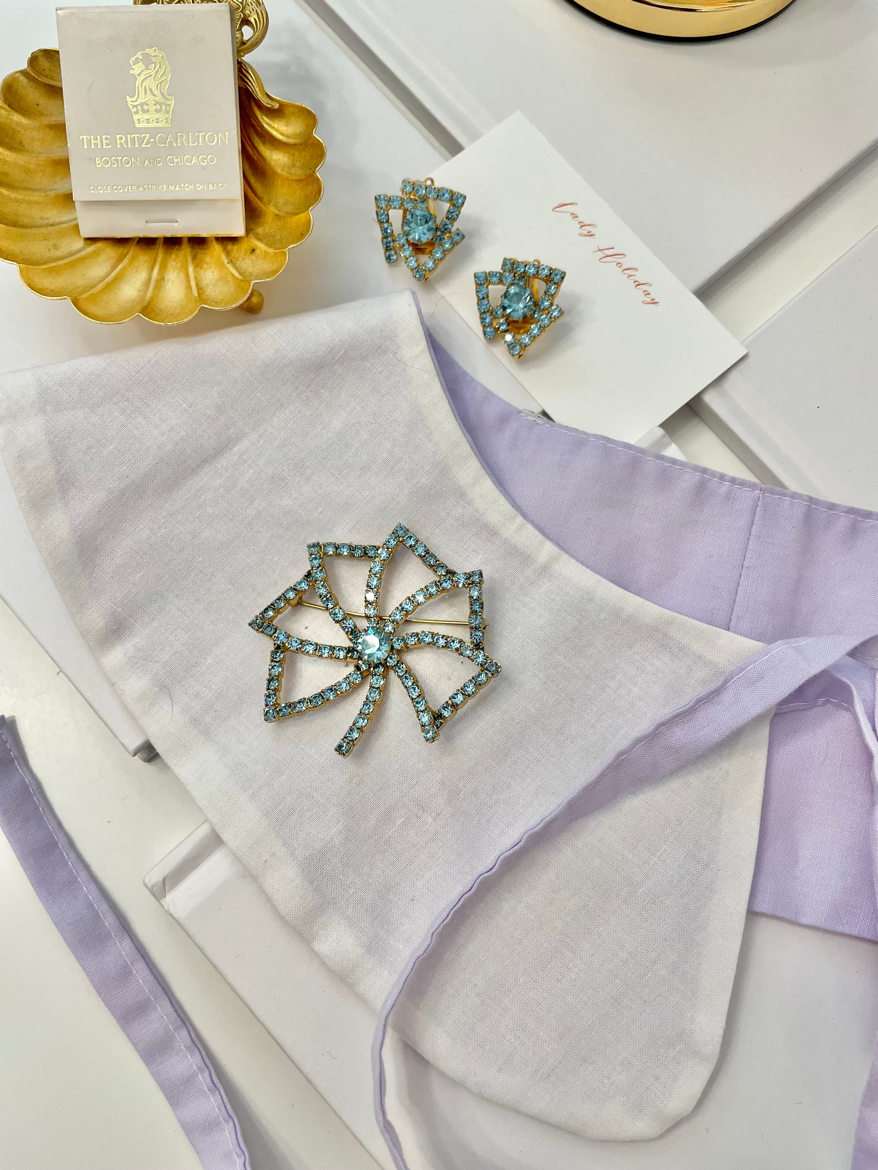 1960's Heiress and her love of a classy brooch set. This aqua glass brooch and earrings are truly divine.