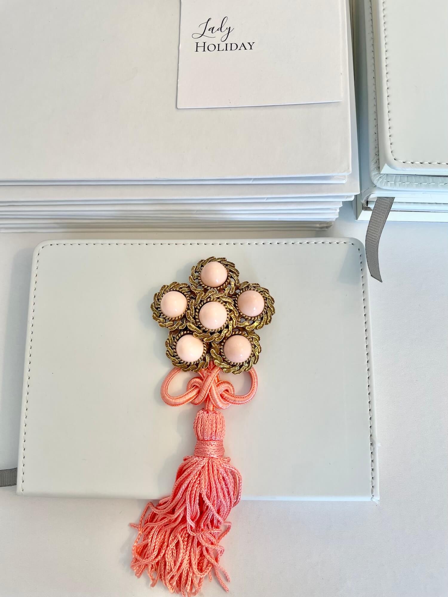 Vintage 1960’s faux angel skin coral brooch, with added tassel for a bit of fun flair!
