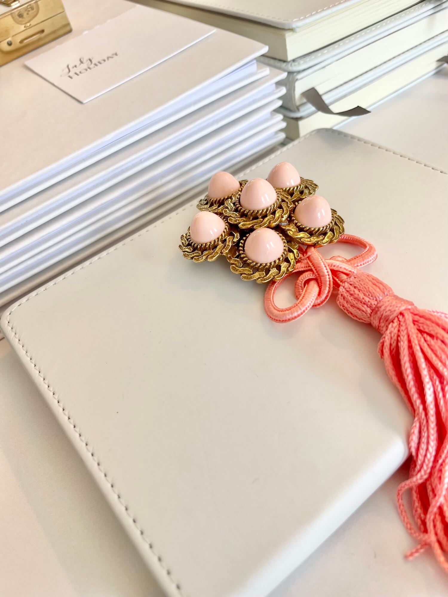 Vintage 1960’s faux angel skin coral brooch, with added tassel for a bit of fun flair!
