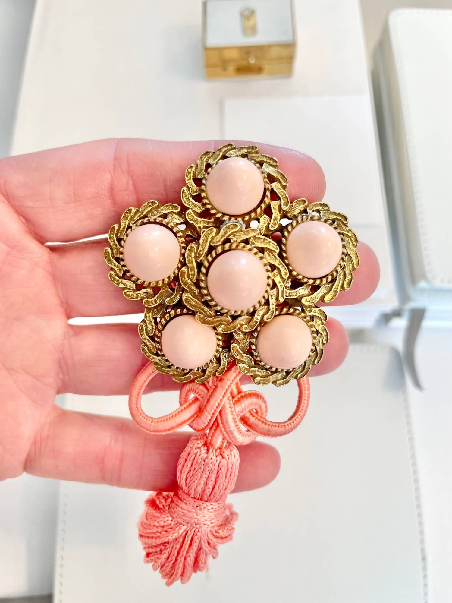 Vintage 1960’s faux angel skin coral brooch, with added tassel for a bit of fun flair!