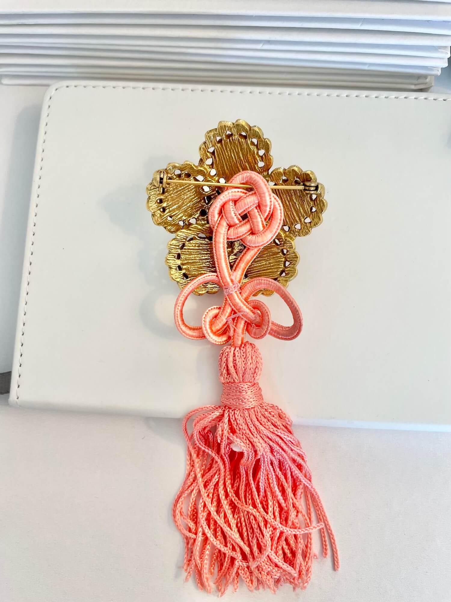 Vintage 1960’s faux angel skin coral brooch, with added tassel for a bit of fun flair!