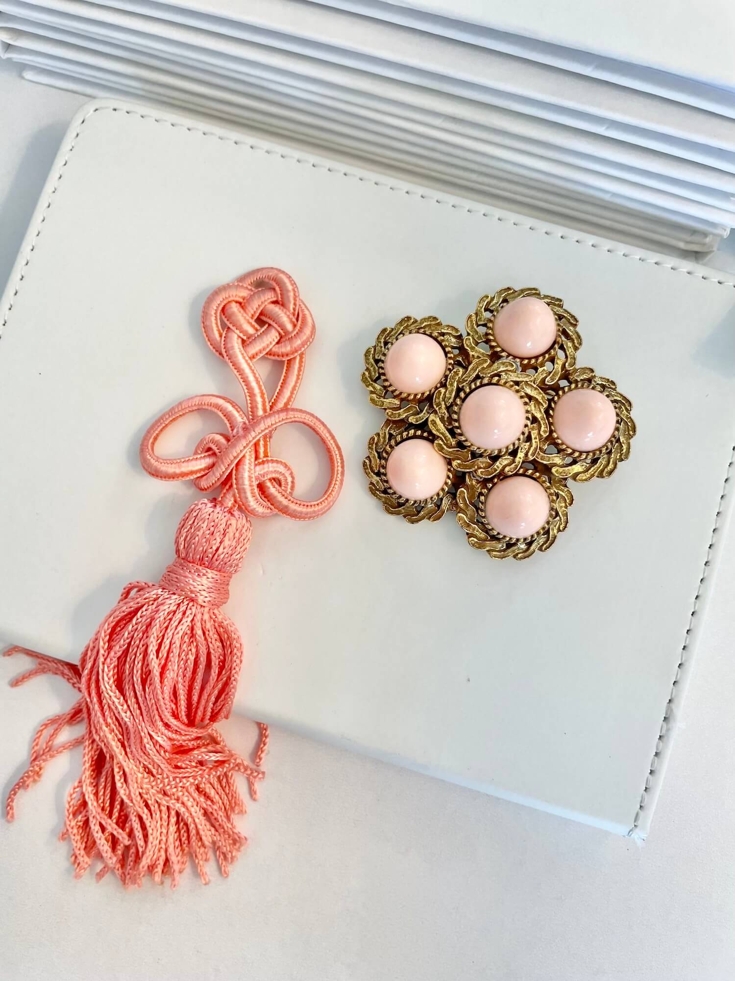Vintage 1960’s faux angel skin coral brooch, with added tassel for a bit of fun flair!