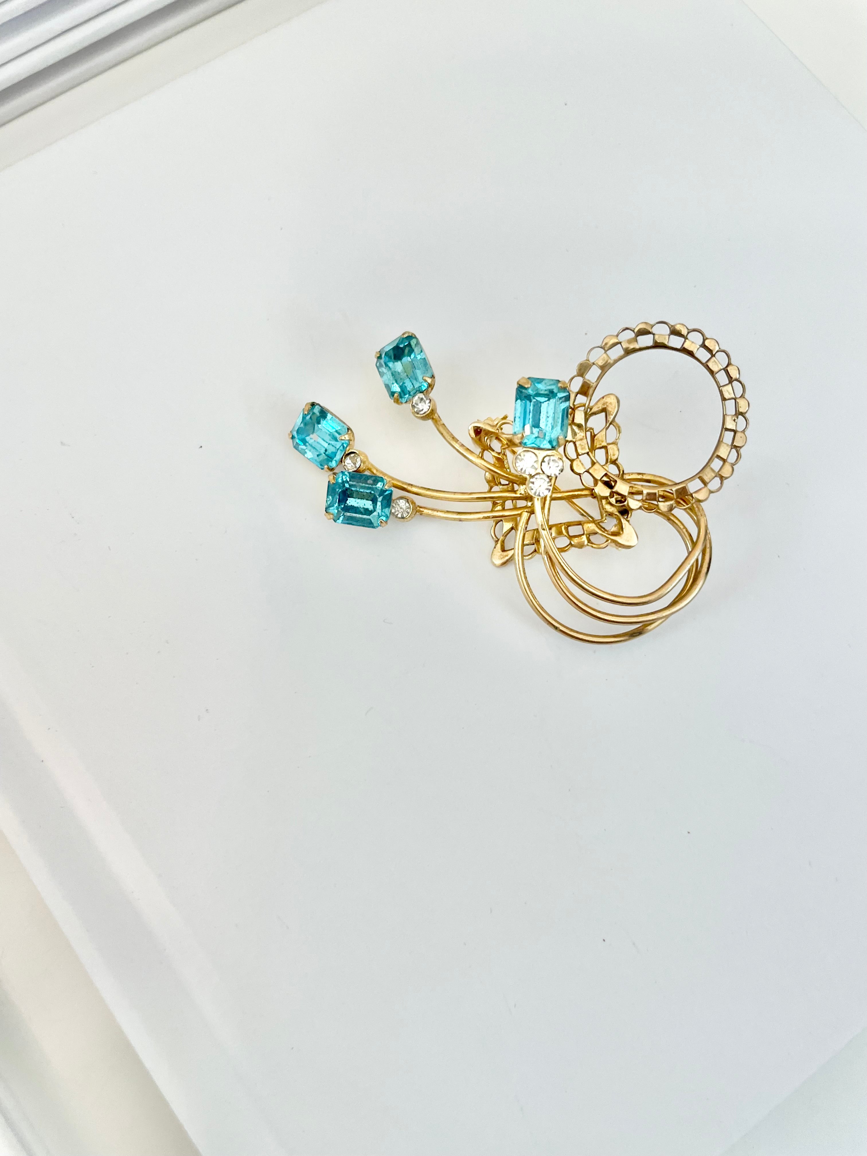 1960's divine gold brooch with emerald cut glass stones.... so classy!