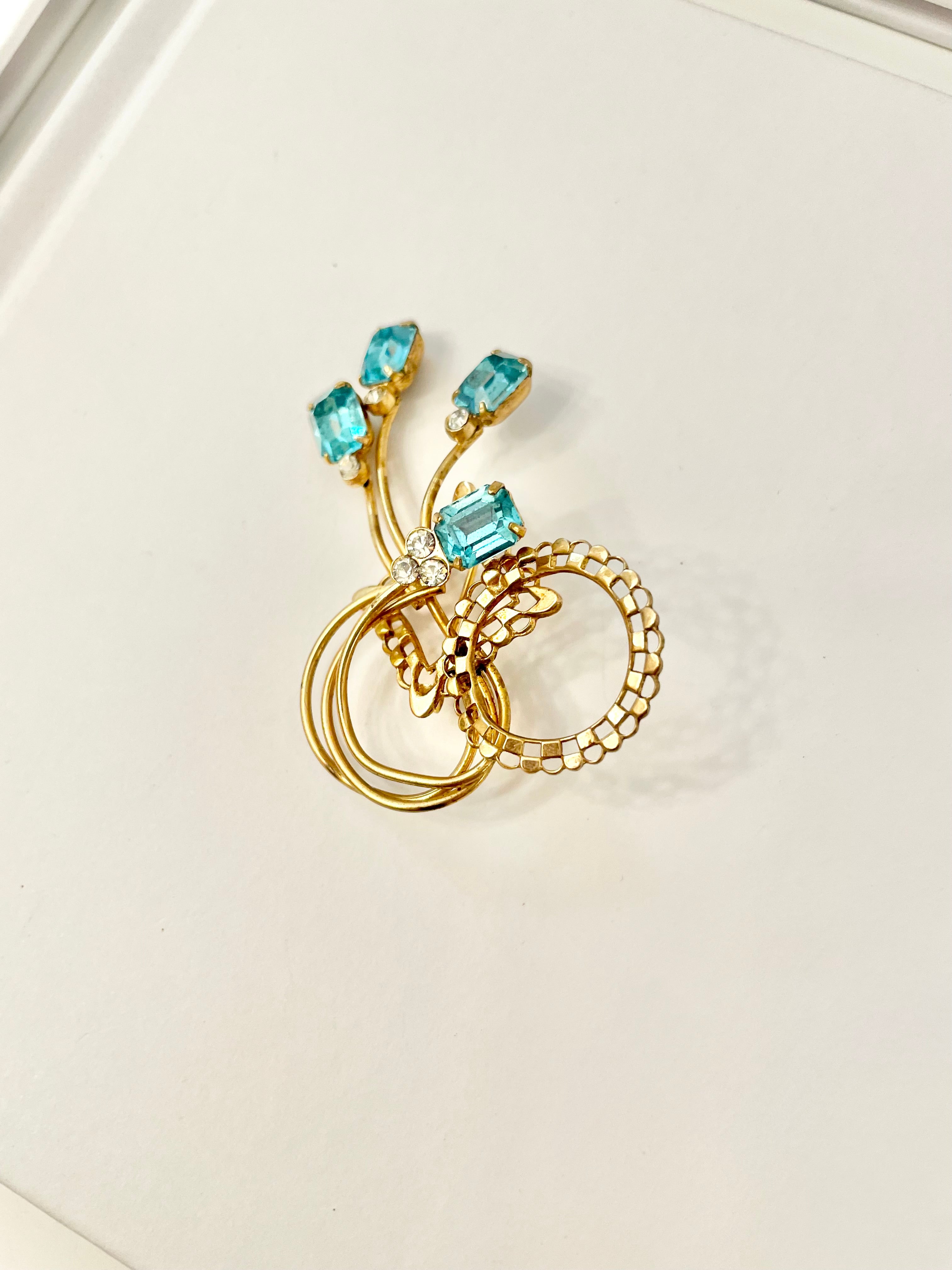 1960's divine gold brooch with emerald cut glass stones.... so classy!