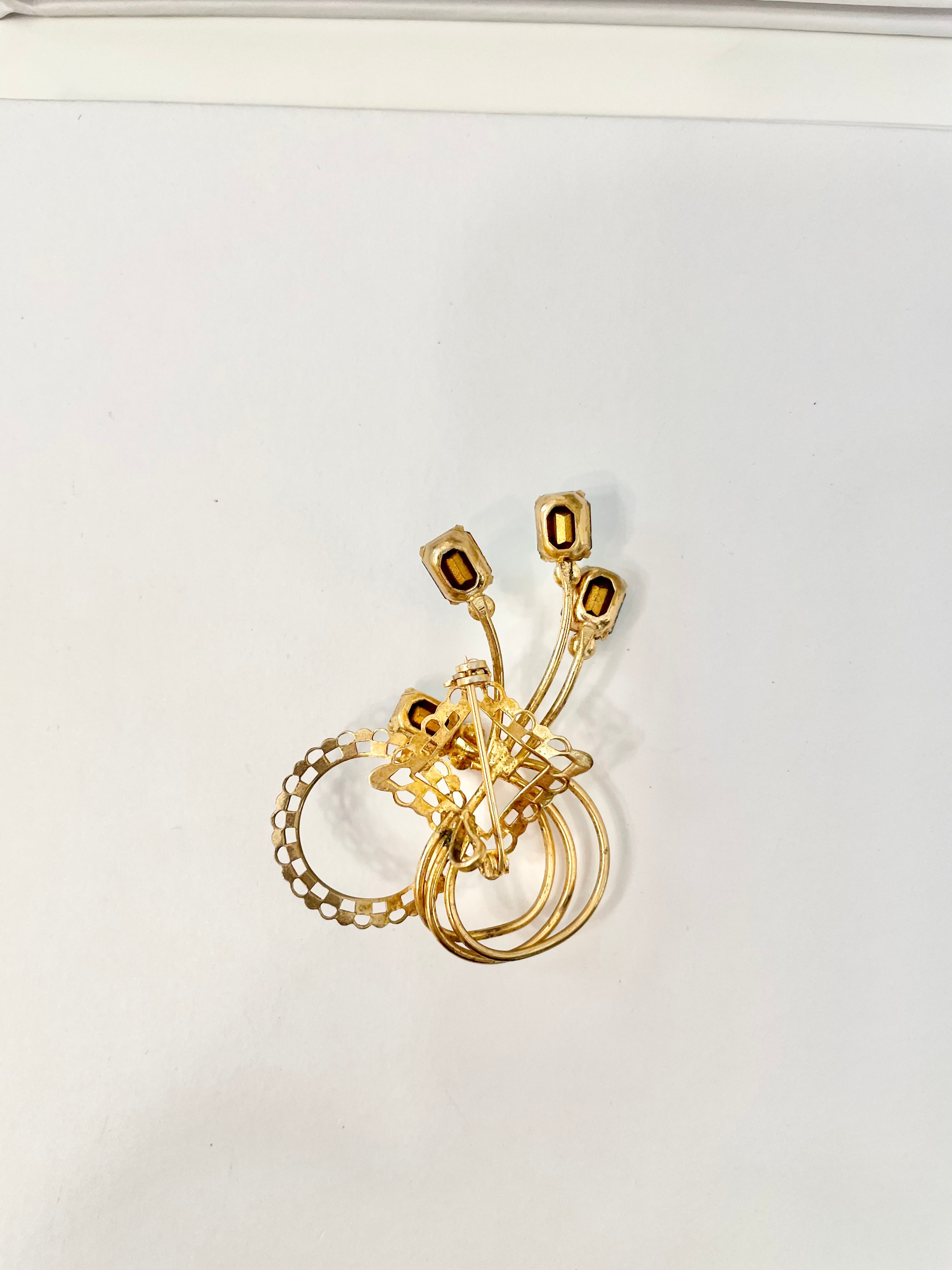 1960's divine gold brooch with emerald cut glass stones.... so classy!