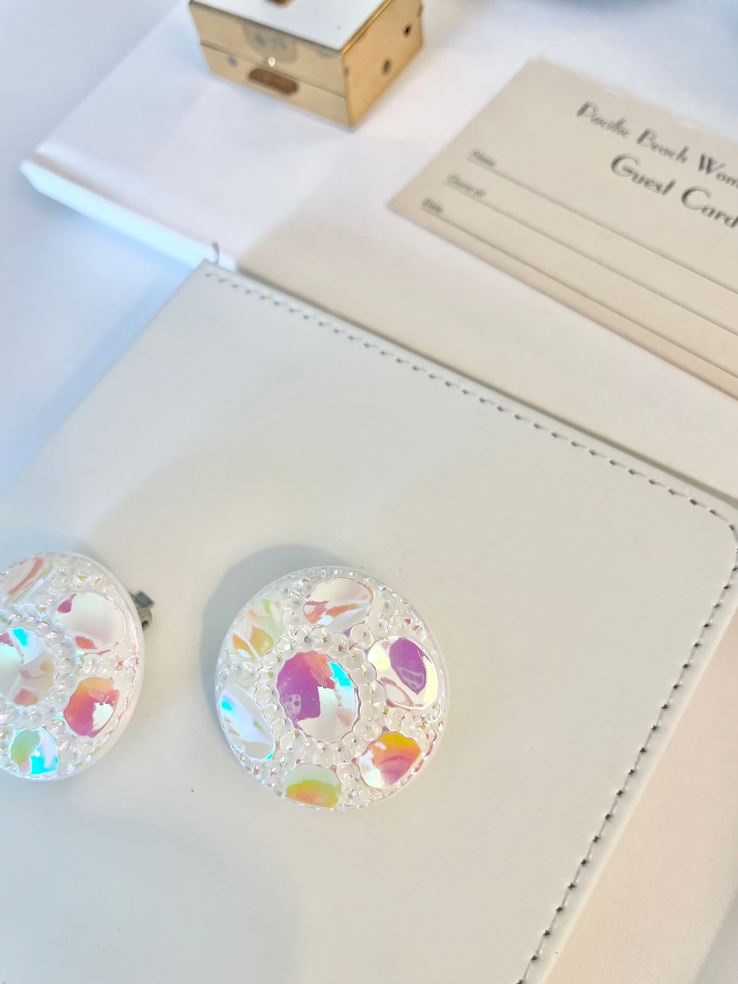 Vintage 1970's shimmery white button clip earrings.