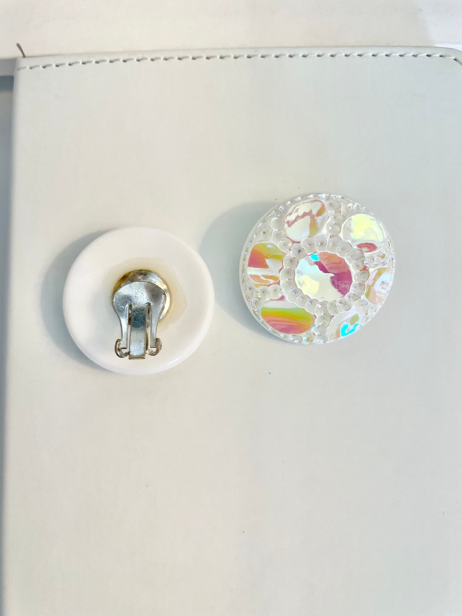 Vintage 1970's shimmery white button clip earrings.