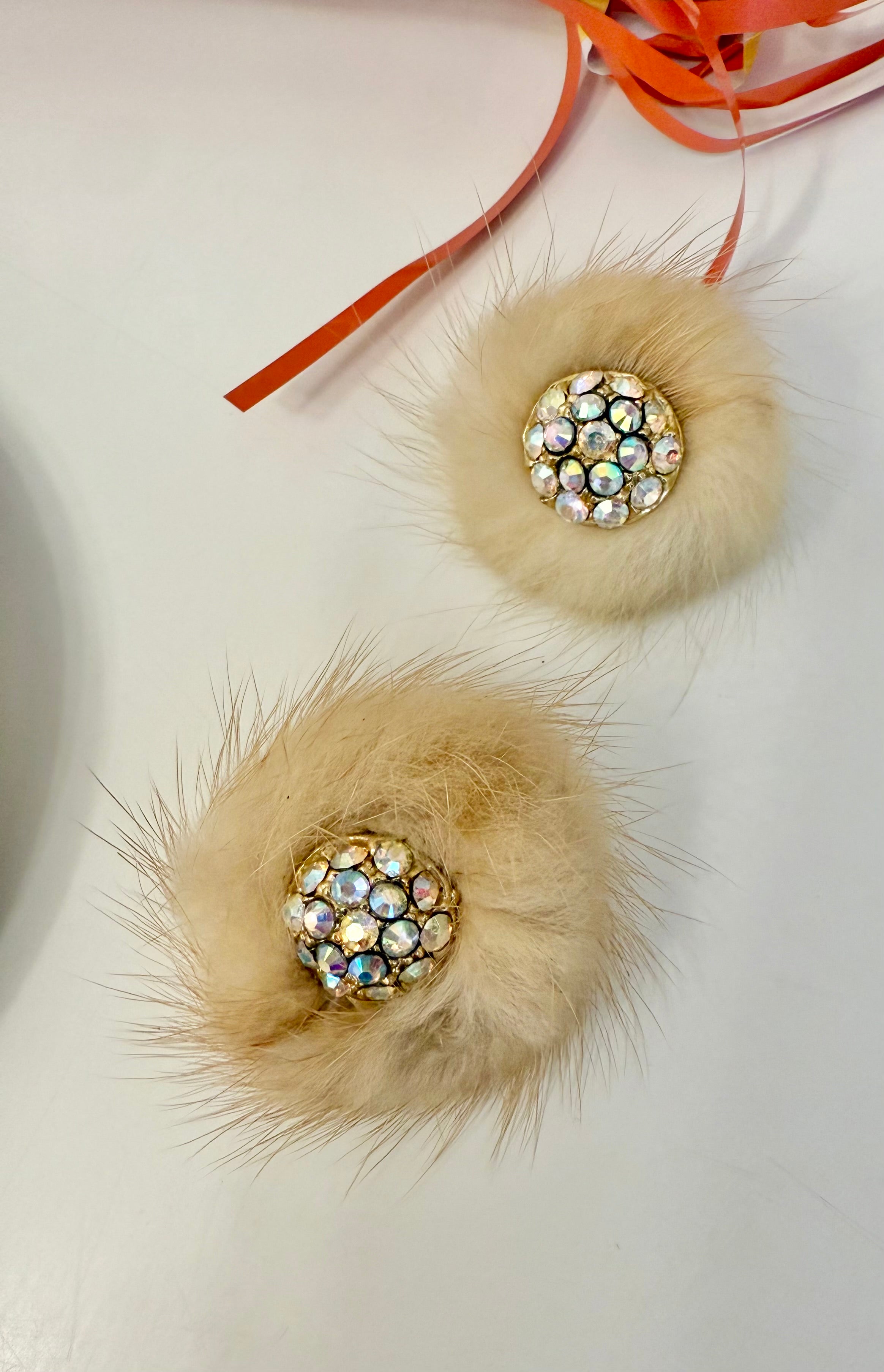 The mink button earring....