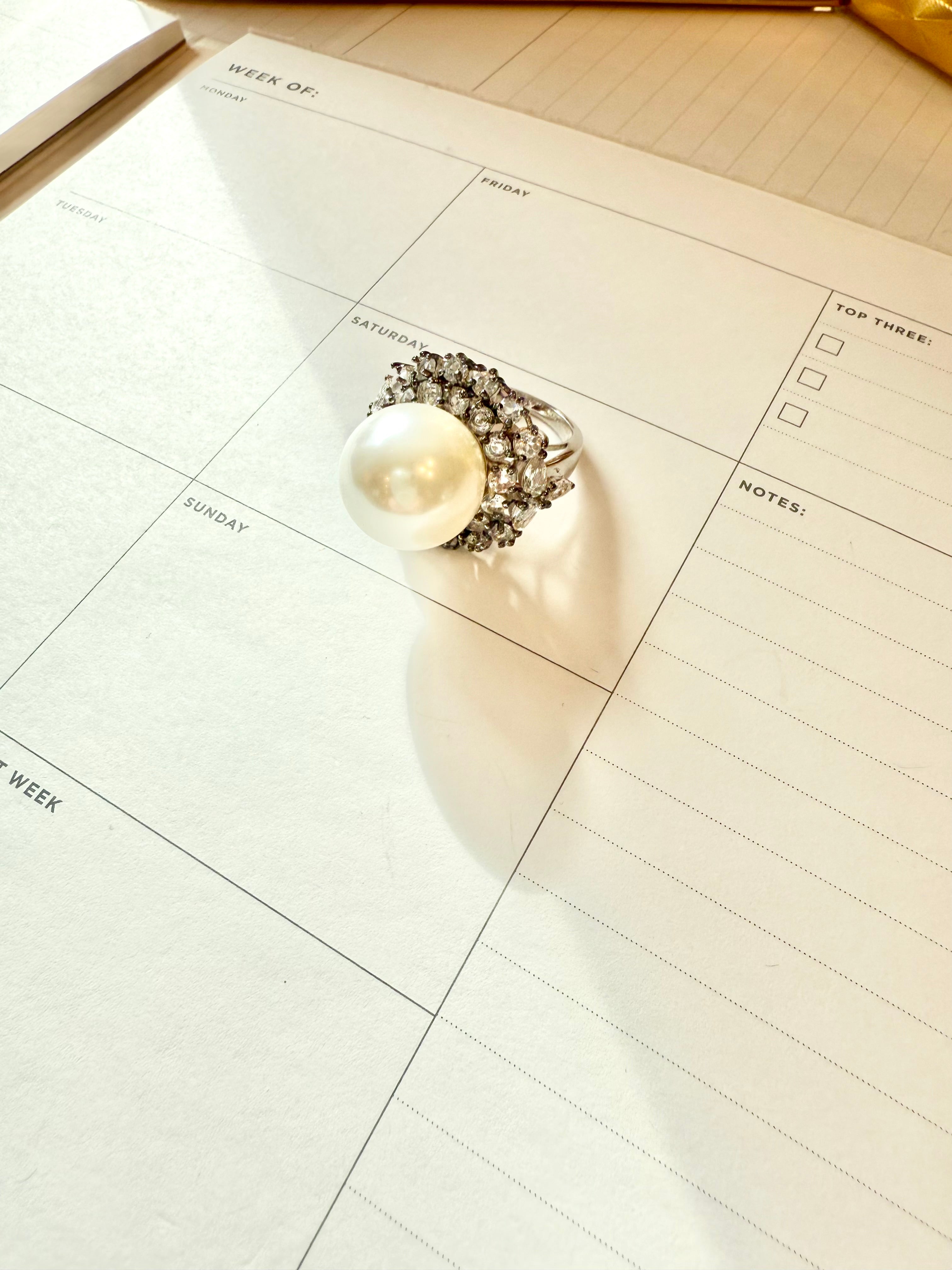 The most divine faux pearl, and white topaz cocktail ring.... elegance