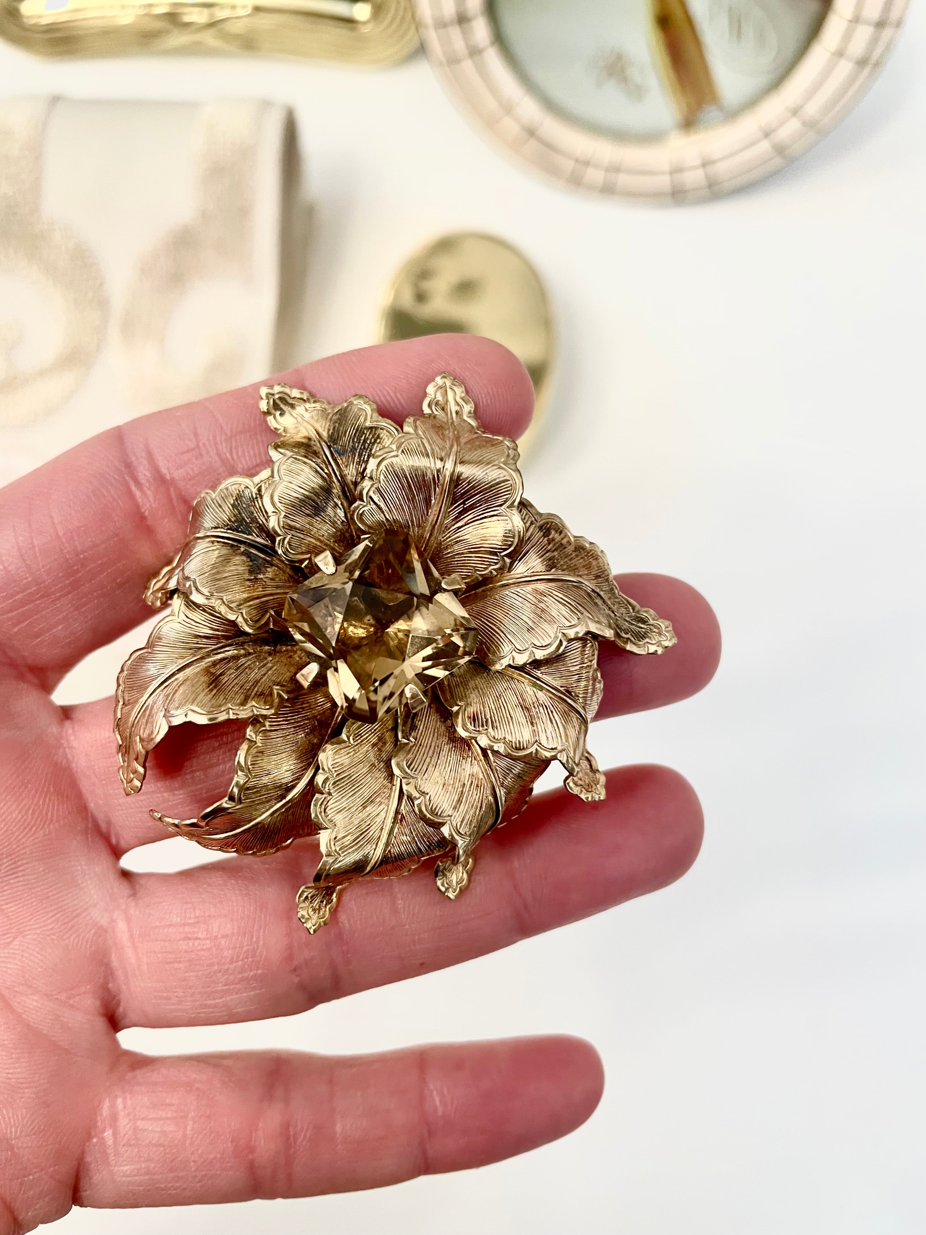 The most lovely estate gold flower brooch with topaz center stone....