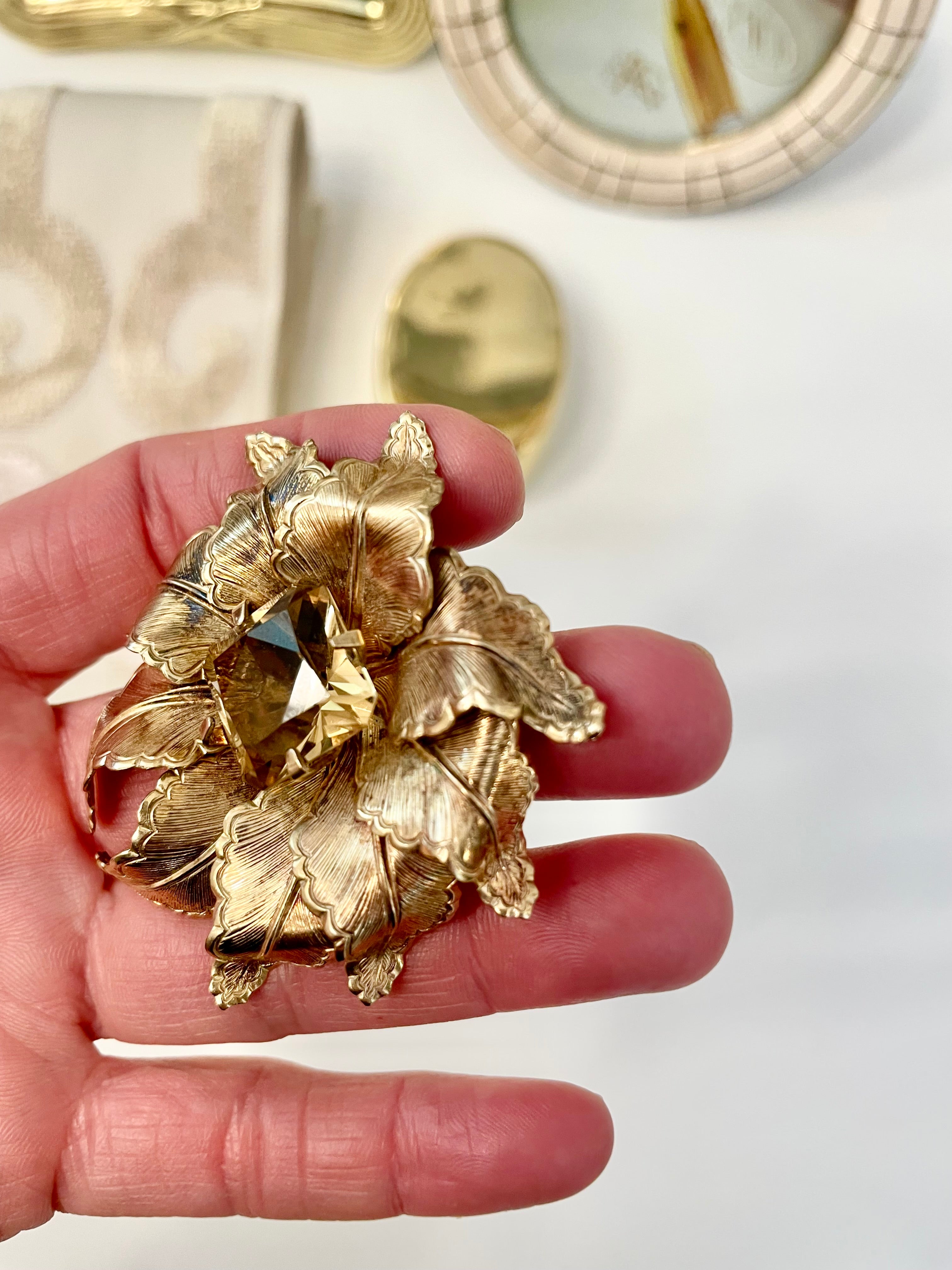The most lovely estate gold flower brooch with topaz center stone....