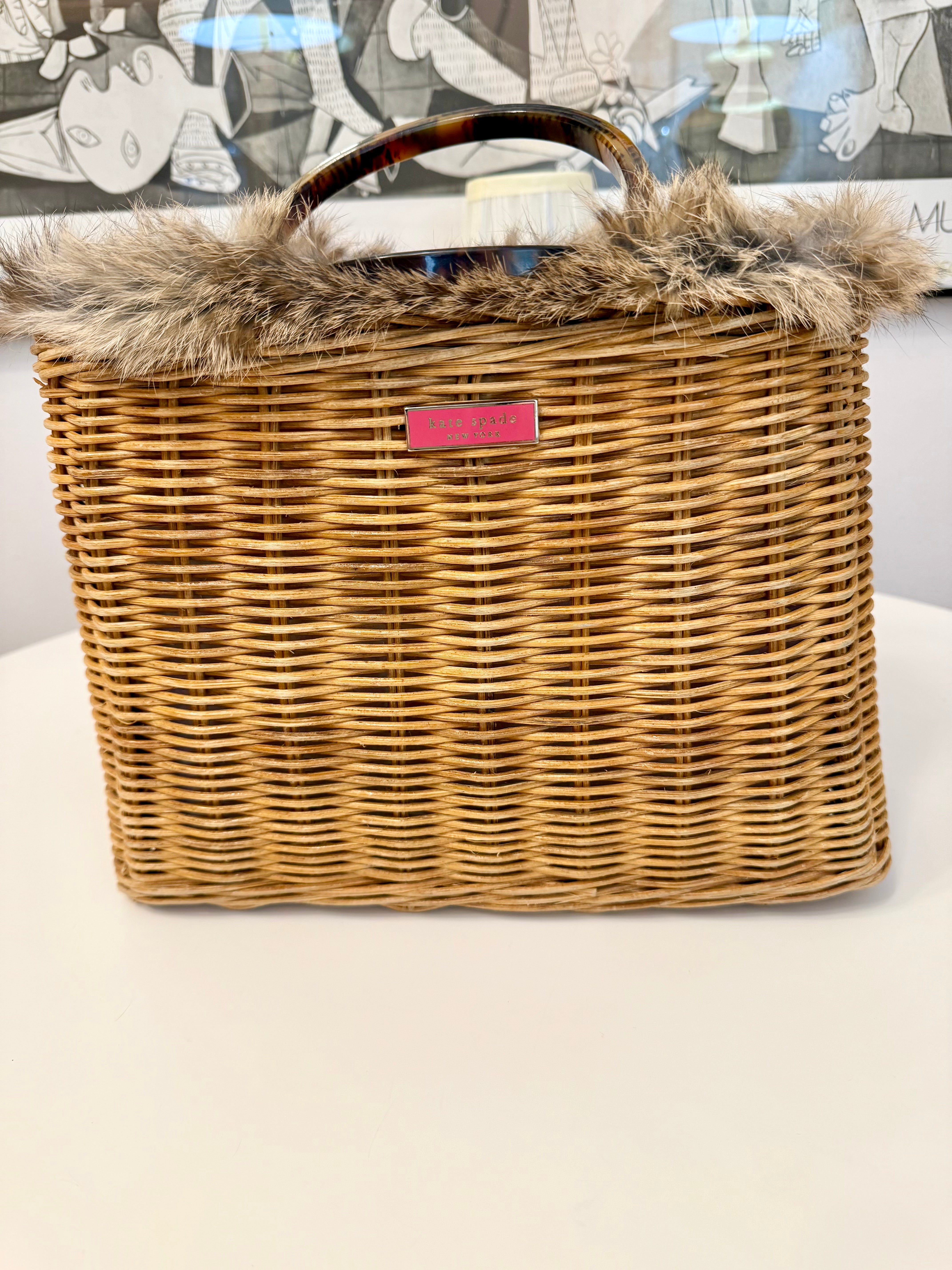 The most darling Kate Spade basket bag trimmed with fox fur....