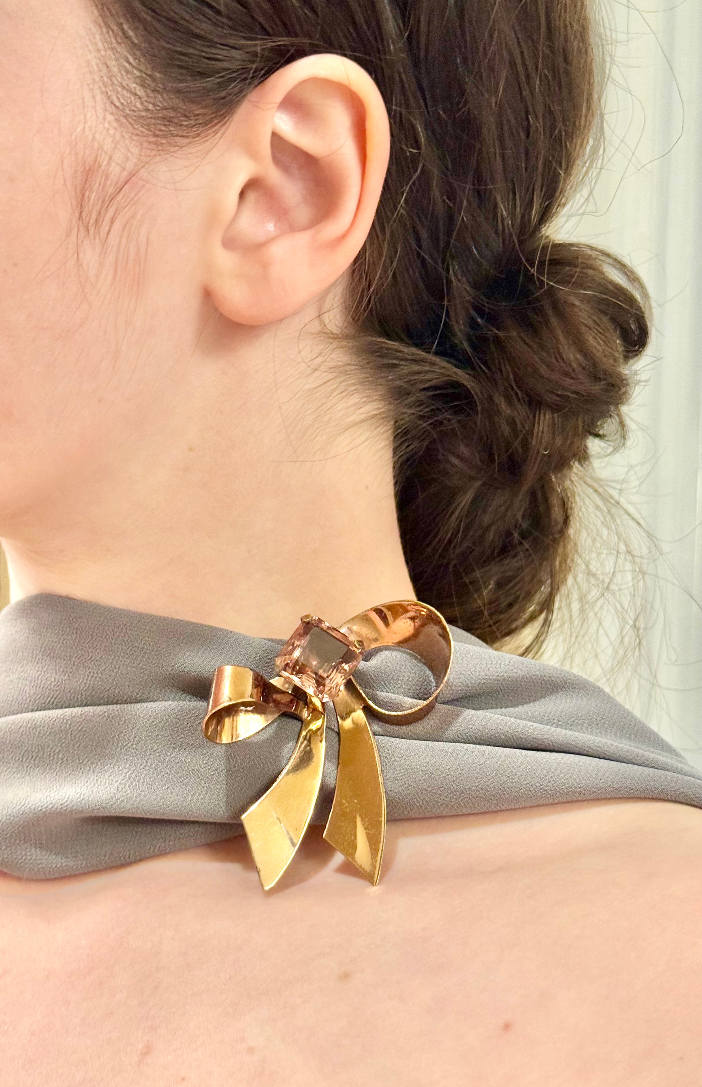 1960's most feminine brass bow with purple glass stone....