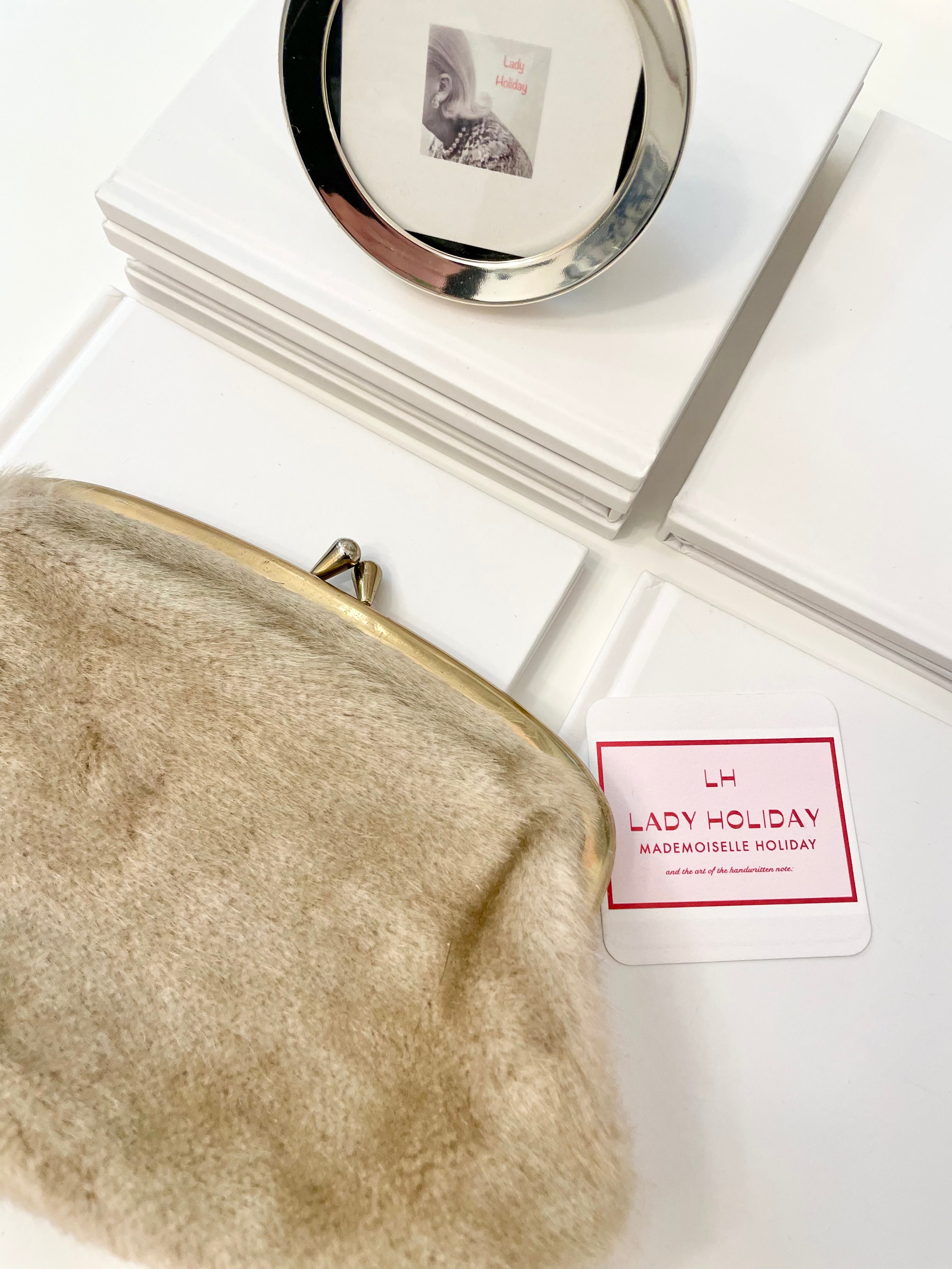 The 1960's Heiress loves a faux mink clutch bag!