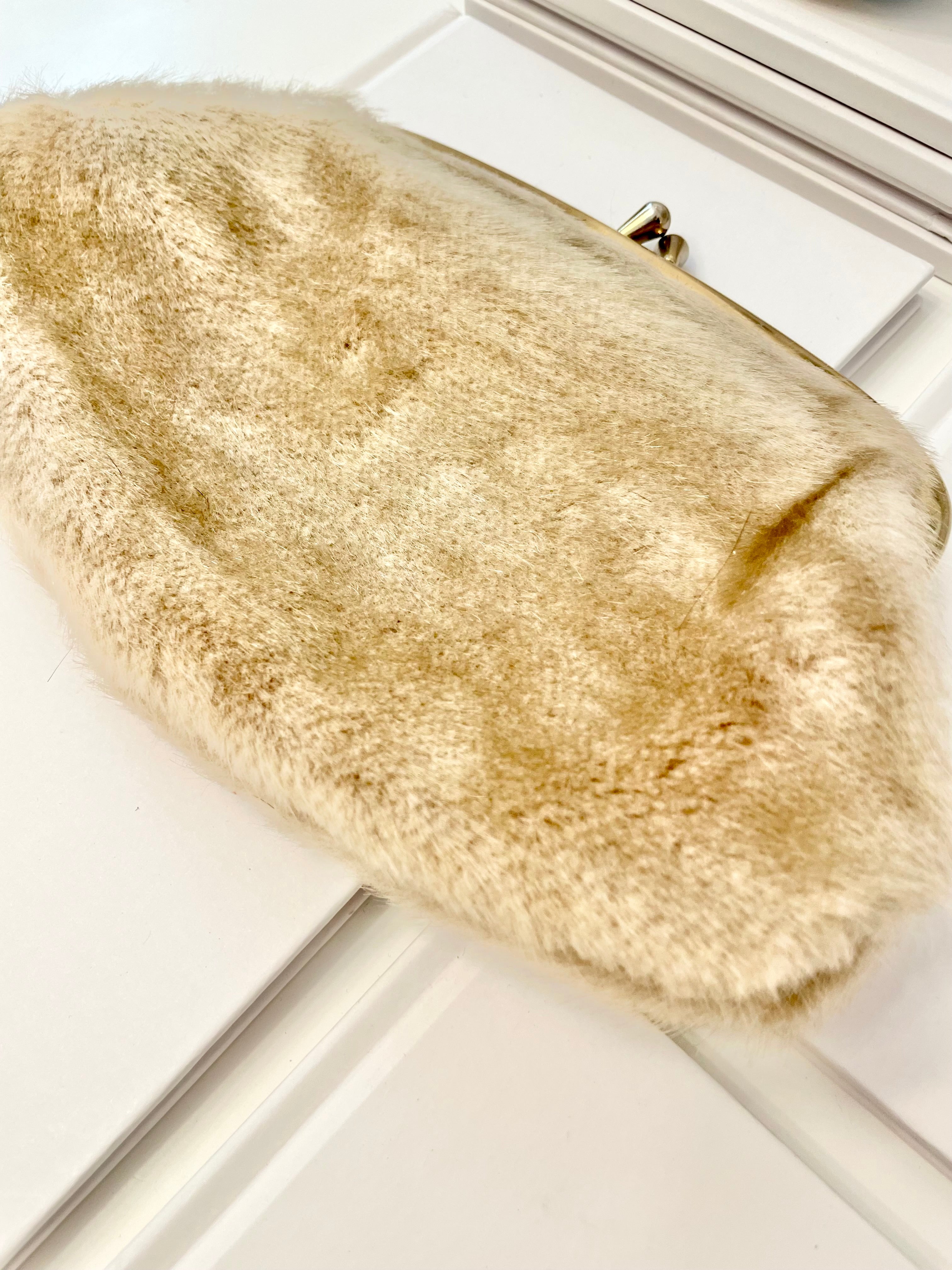 The 1960's Heiress loves a faux mink clutch bag!