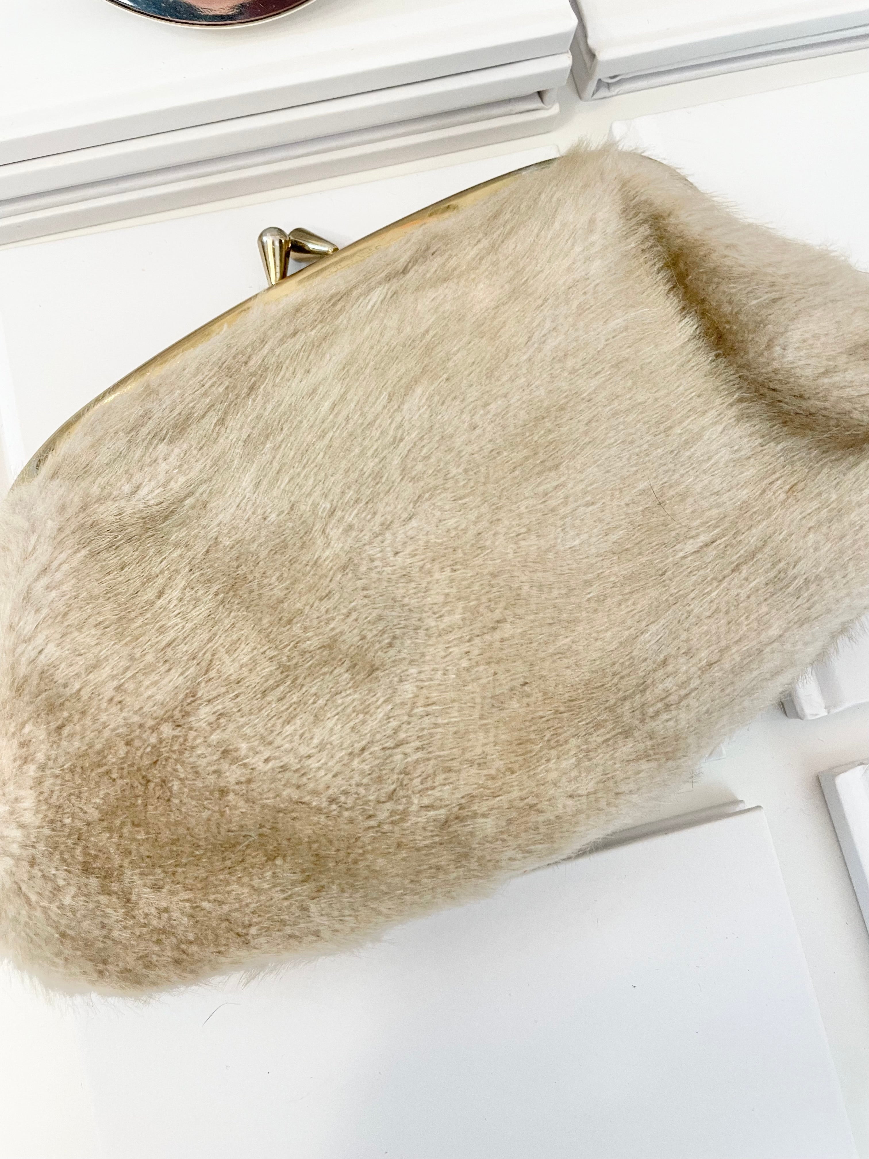 The 1960's Heiress loves a faux mink clutch bag!