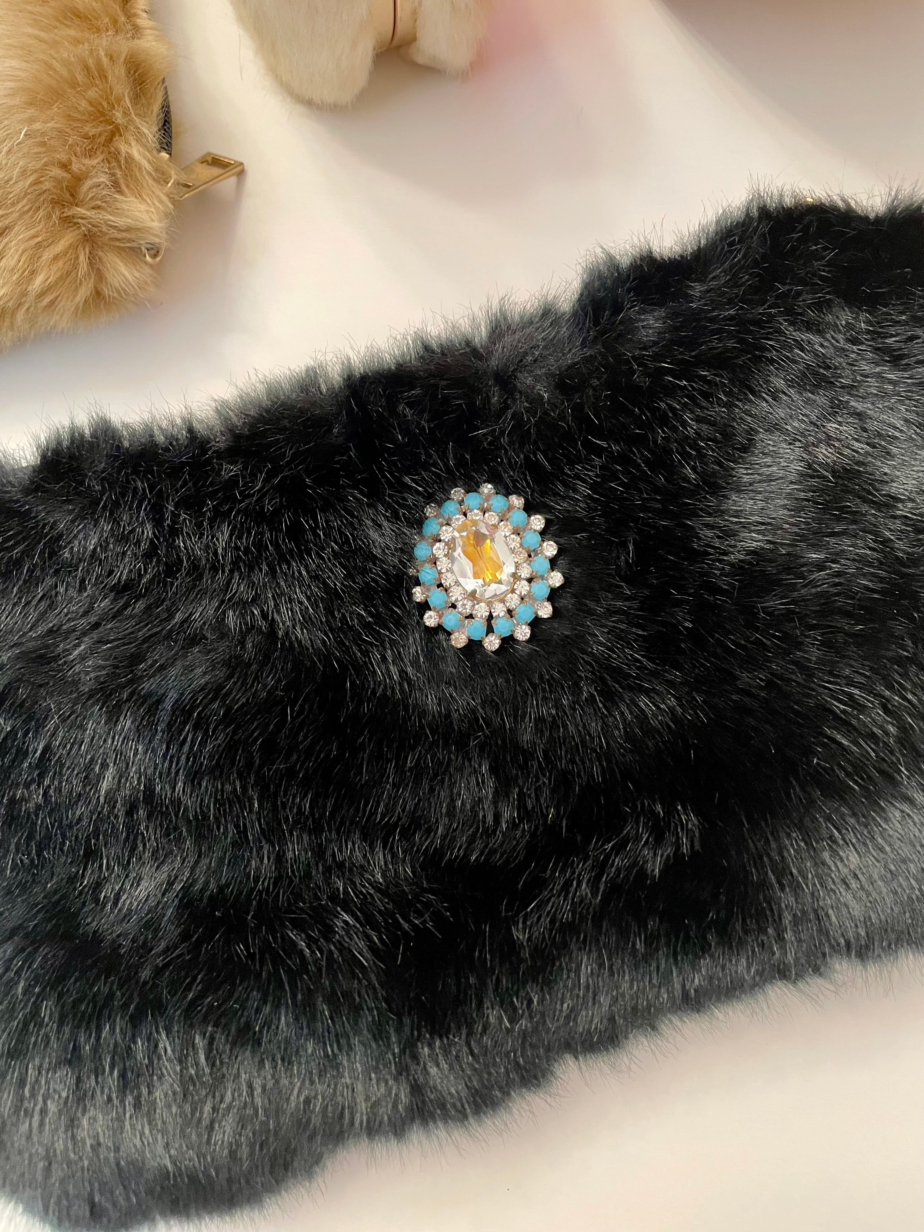 Ladies on Holiday, and her love of a classy evening bag! This noir faux fur clutch bag is so charming..