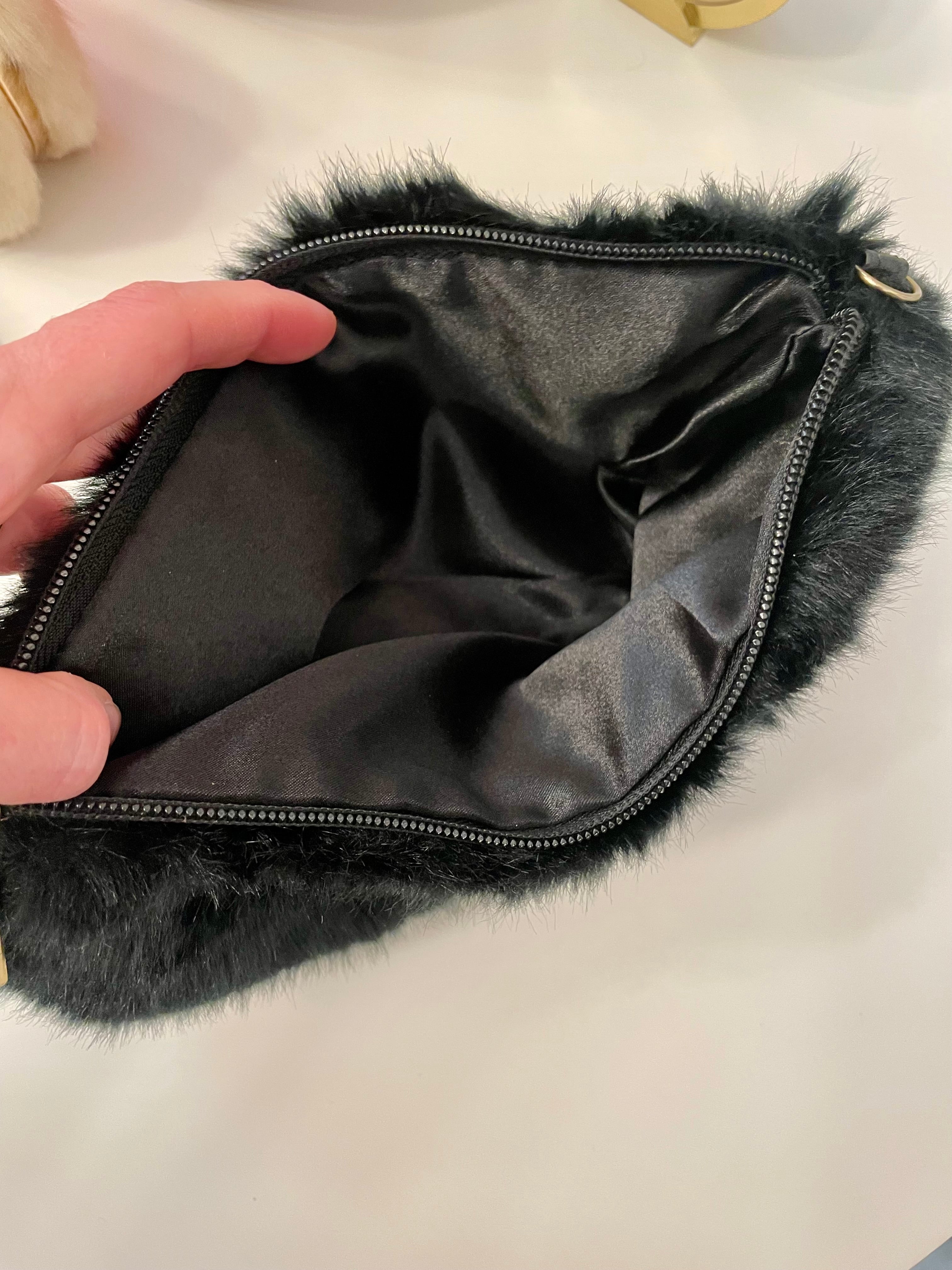 Ladies on Holiday, and her love of a classy evening bag! This noir faux fur clutch bag is so charming..