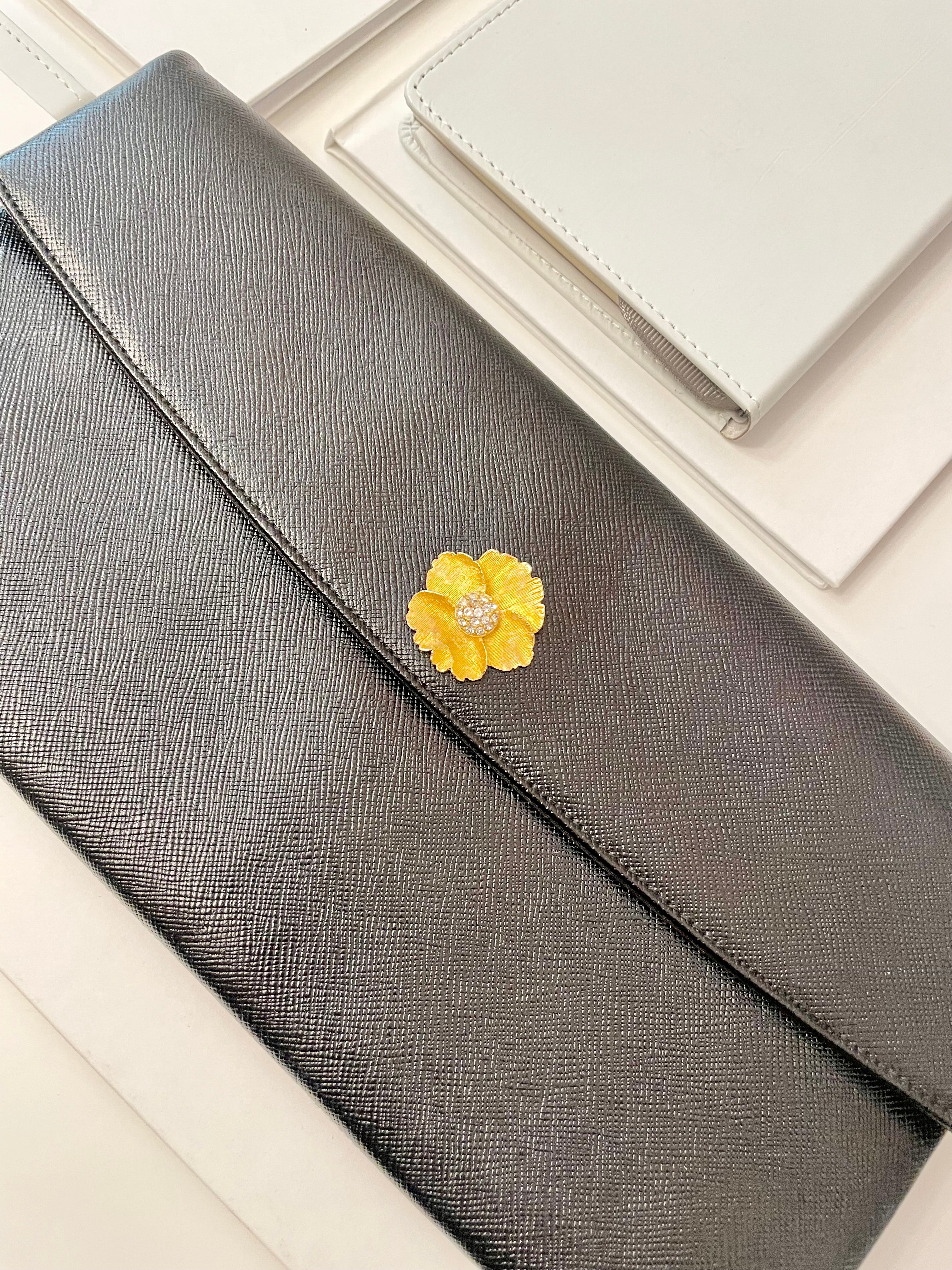 Vintage 1960's Prestige noir clutch bag for Saks Fifth Avenue, adorned with chic gold flower..so lady like!