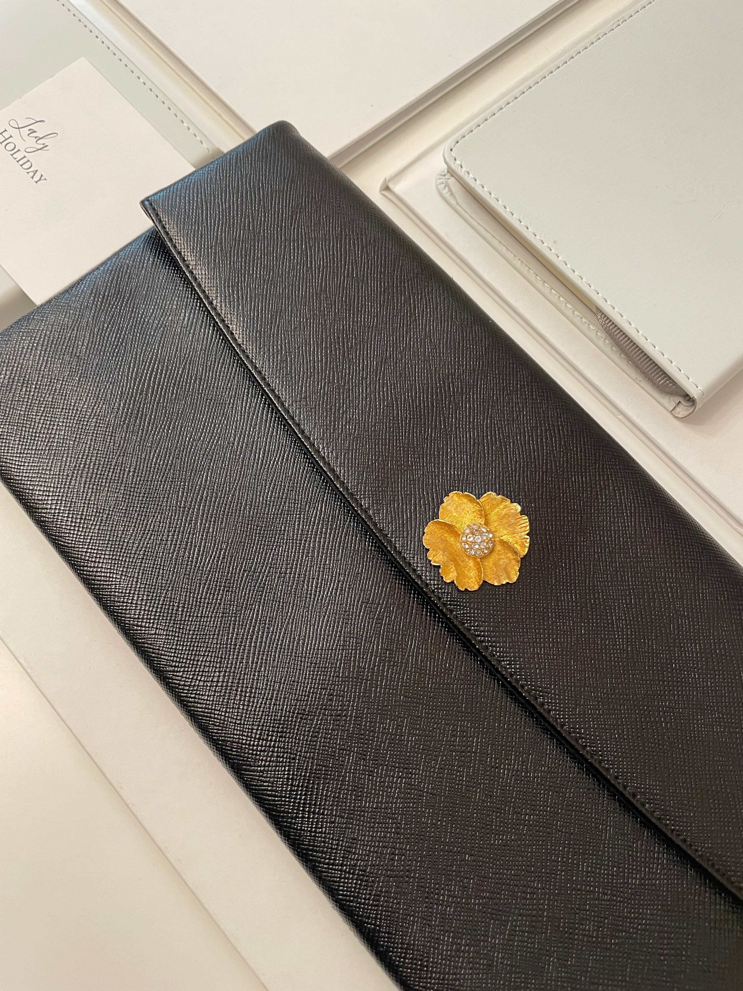 Vintage 1960's Prestige noir clutch bag for Saks Fifth Avenue, adorned with chic gold flower..so lady like!