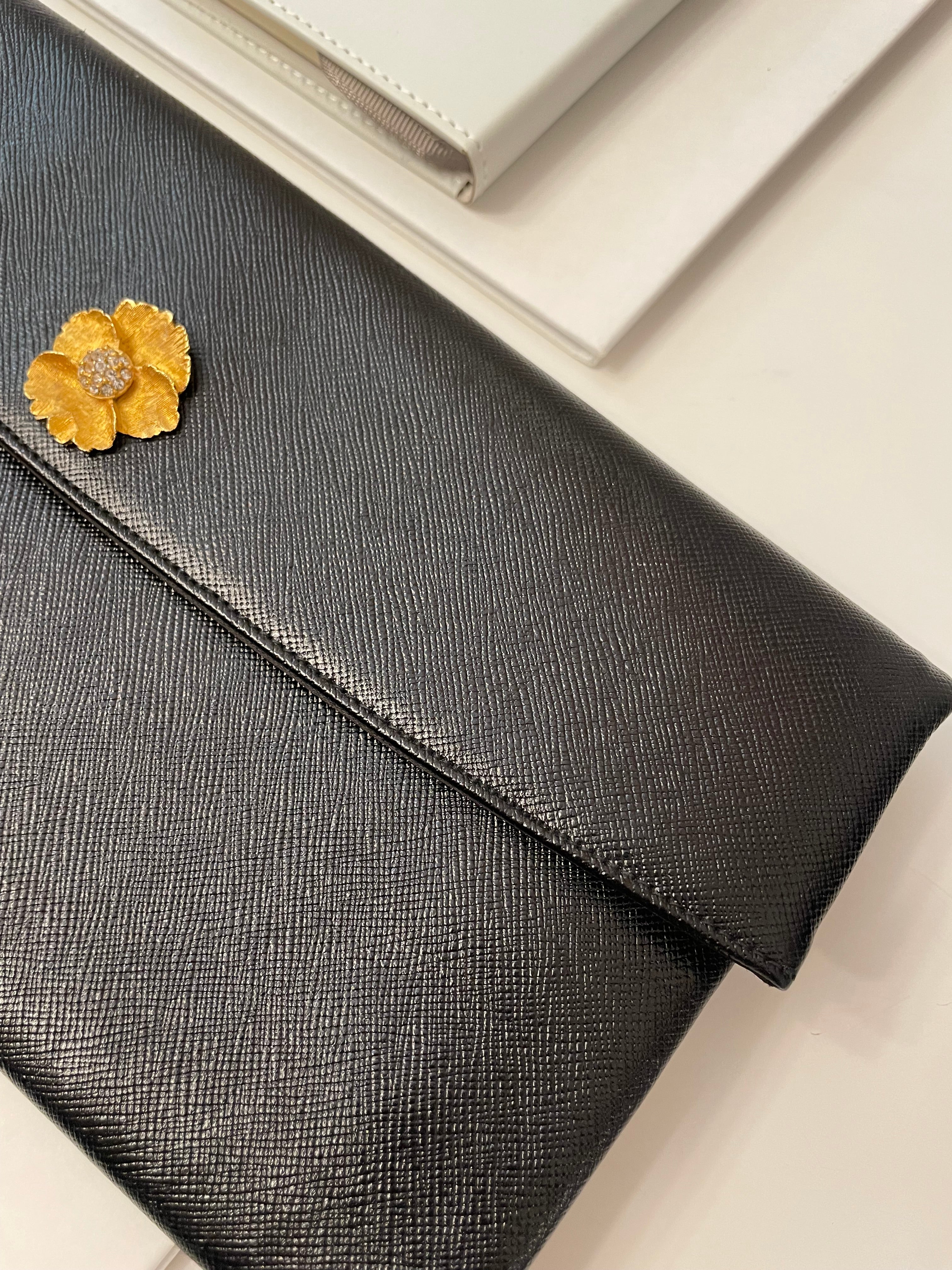 Vintage 1960's Prestige noir clutch bag for Saks Fifth Avenue, adorned with chic gold flower..so lady like!