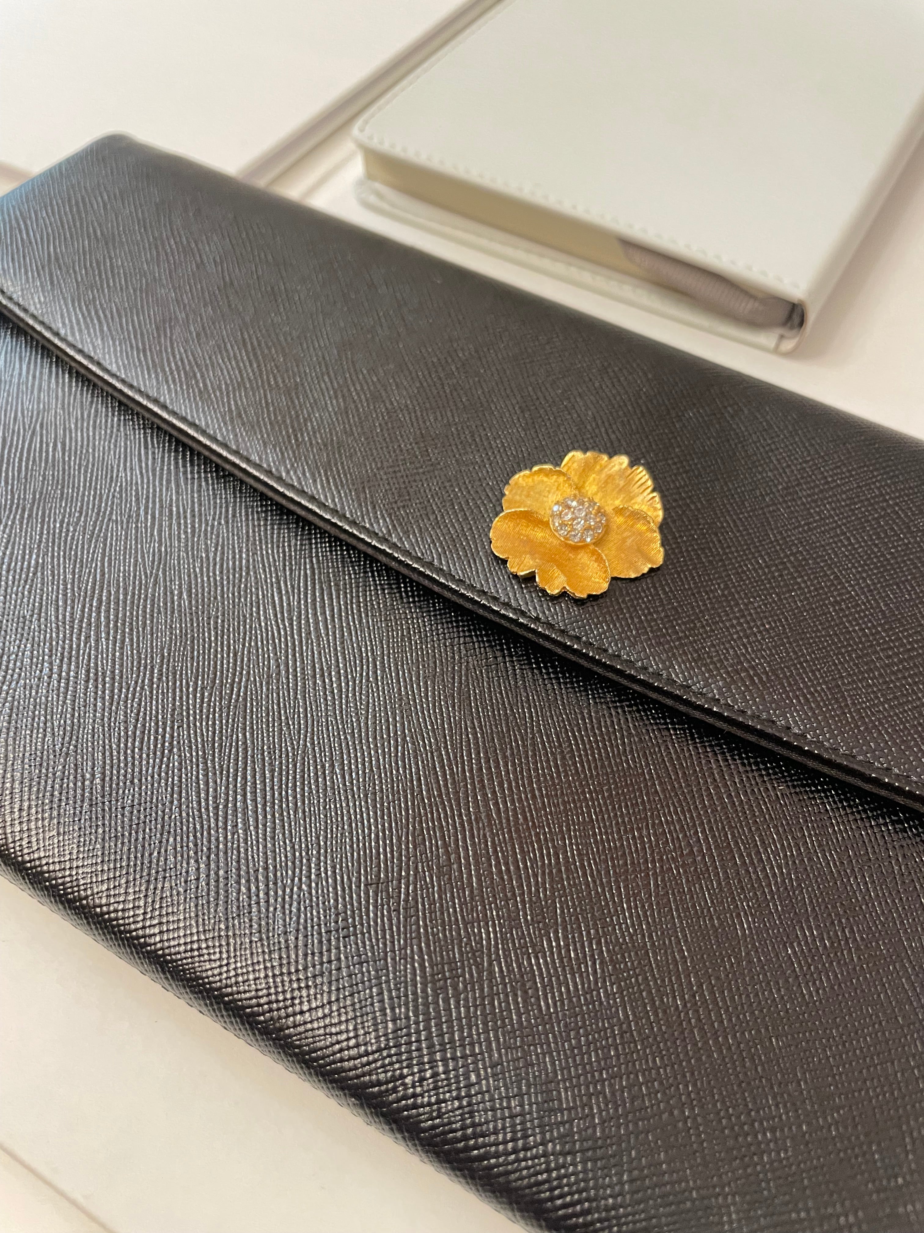 Vintage 1960's Prestige noir clutch bag for Saks Fifth Avenue, adorned with chic gold flower..so lady like!