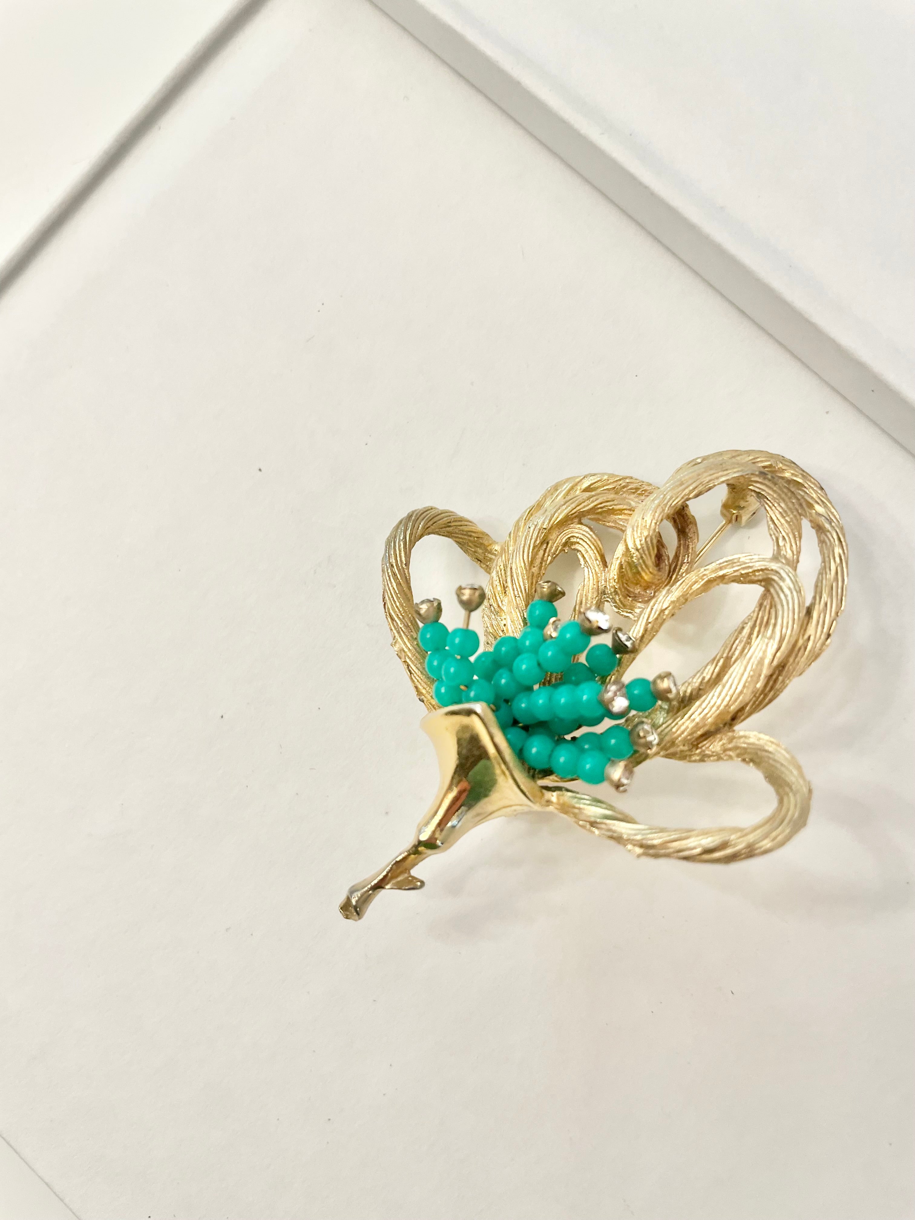 A truly classic brooch for a classy lady... love this bottle green beaded brooch with a sprig of clear glass stones, set in gold! so lovely