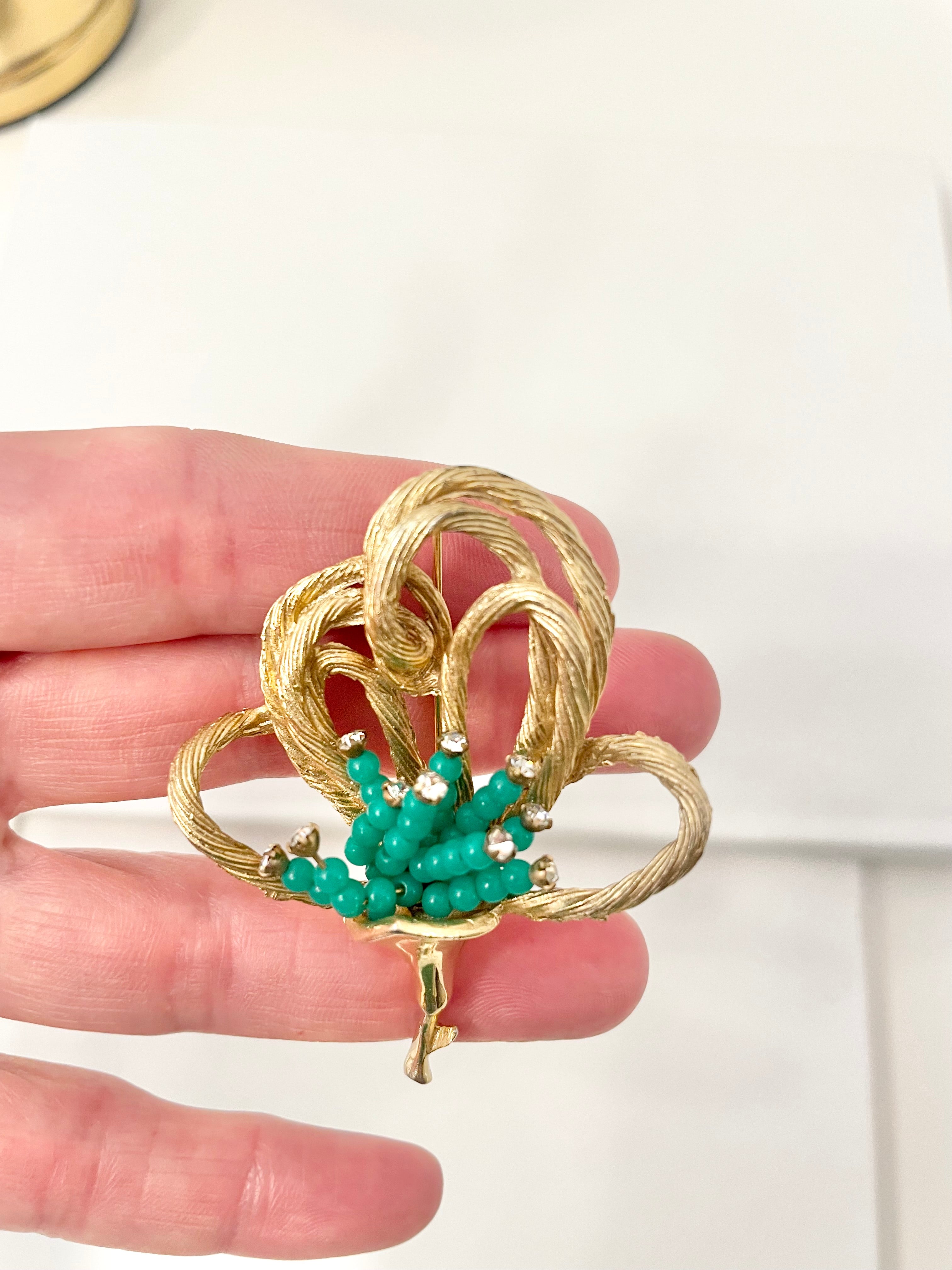A truly classic brooch for a classy lady... love this bottle green beaded brooch with a sprig of clear glass stones, set in gold! so lovely