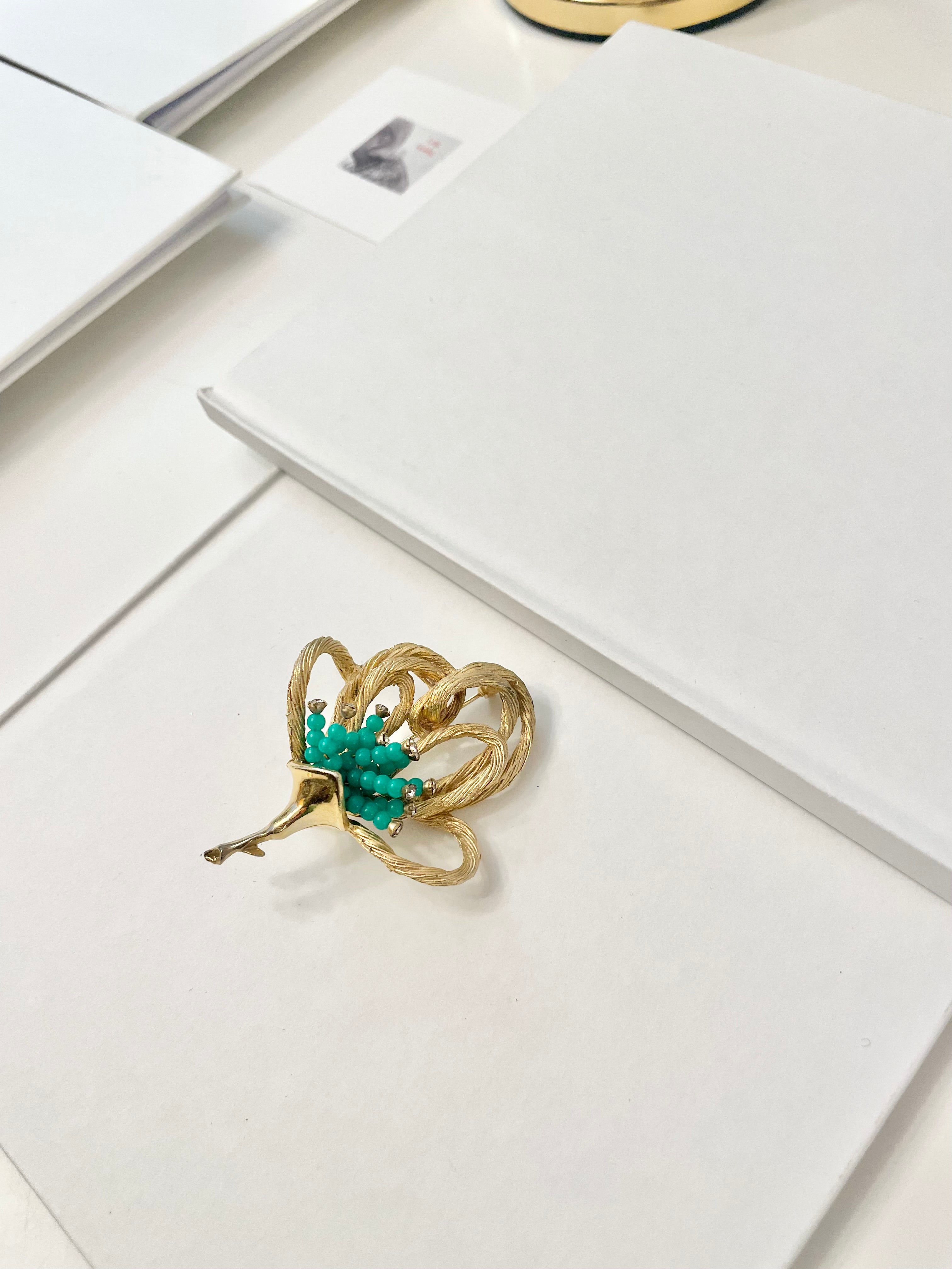 A truly classic brooch for a classy lady... love this bottle green beaded brooch with a sprig of clear glass stones, set in gold! so lovely