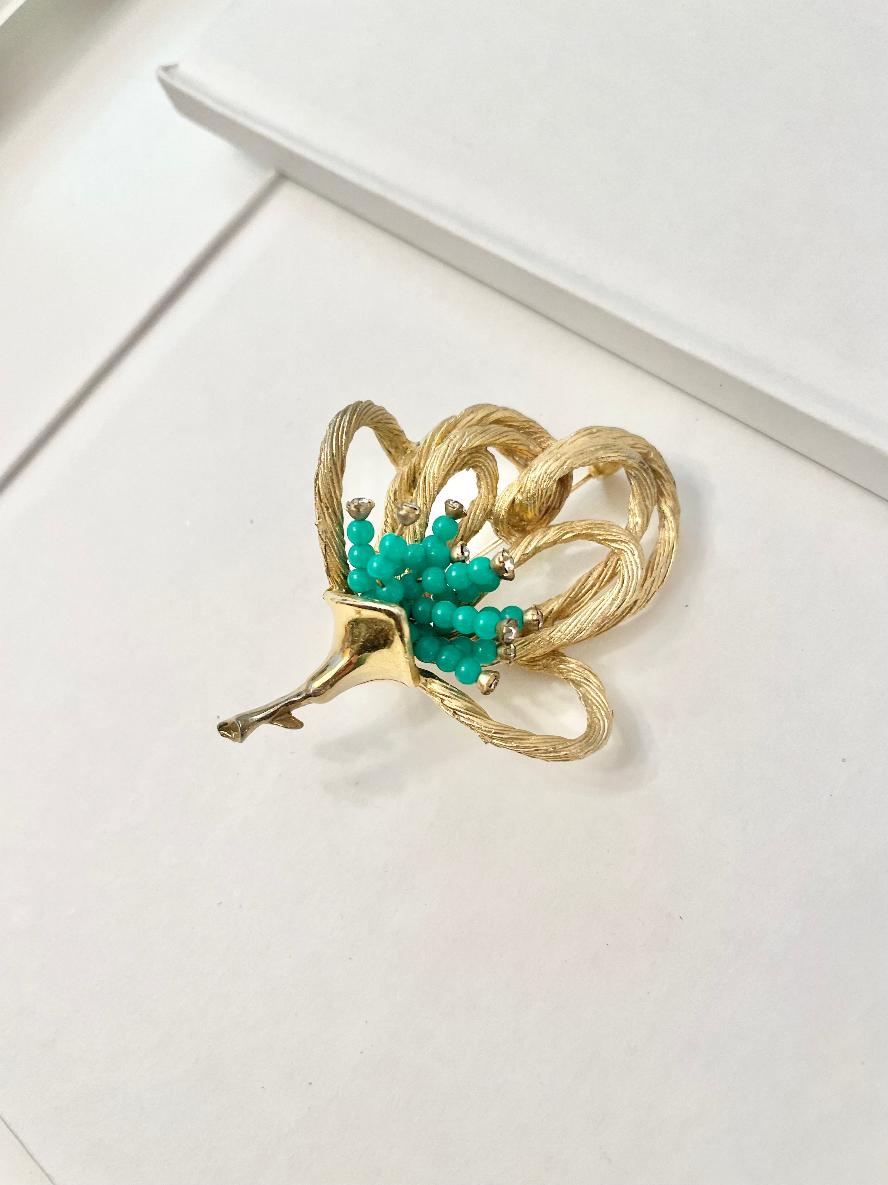 A truly classic brooch for a classy lady... love this bottle green beaded brooch with a sprig of clear glass stones, set in gold! so lovely