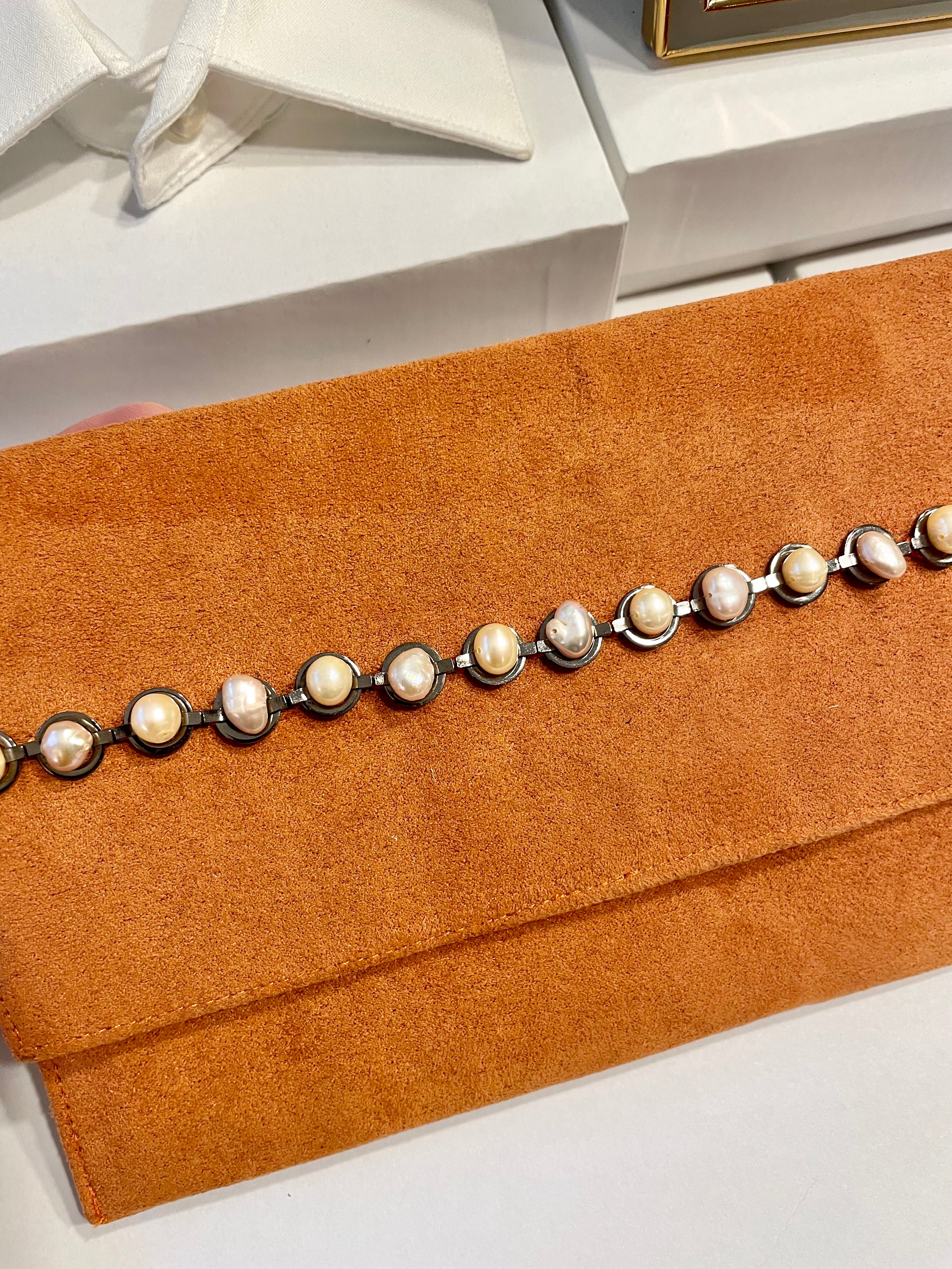 Isn't she Charming... she adores anything with pearls! This one of a kind fresh water pearl clutch, is so chic!