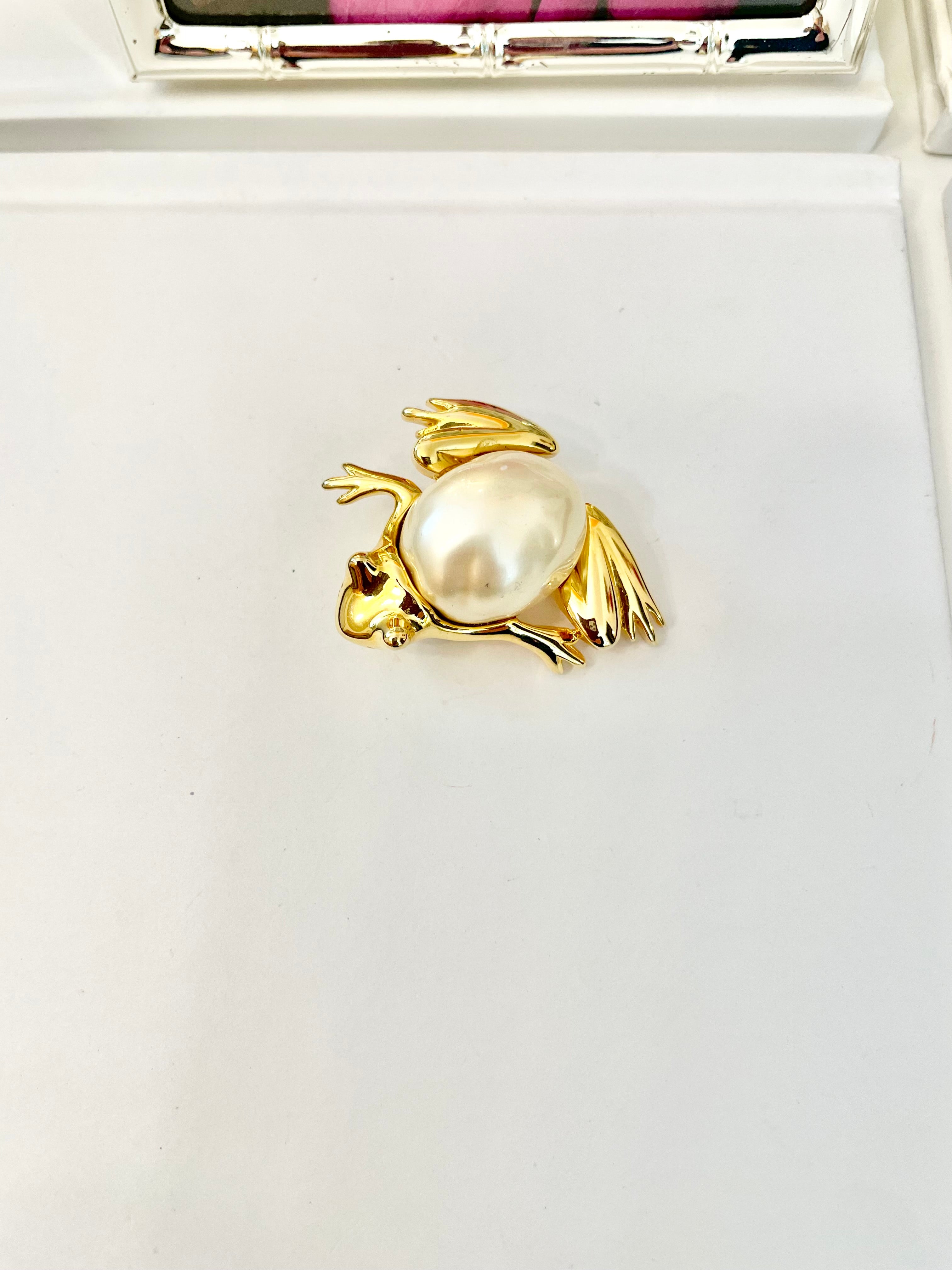 The charming lady loves anything with pearls. This Kenneth Jay lane figural gold brooch is truly divine!