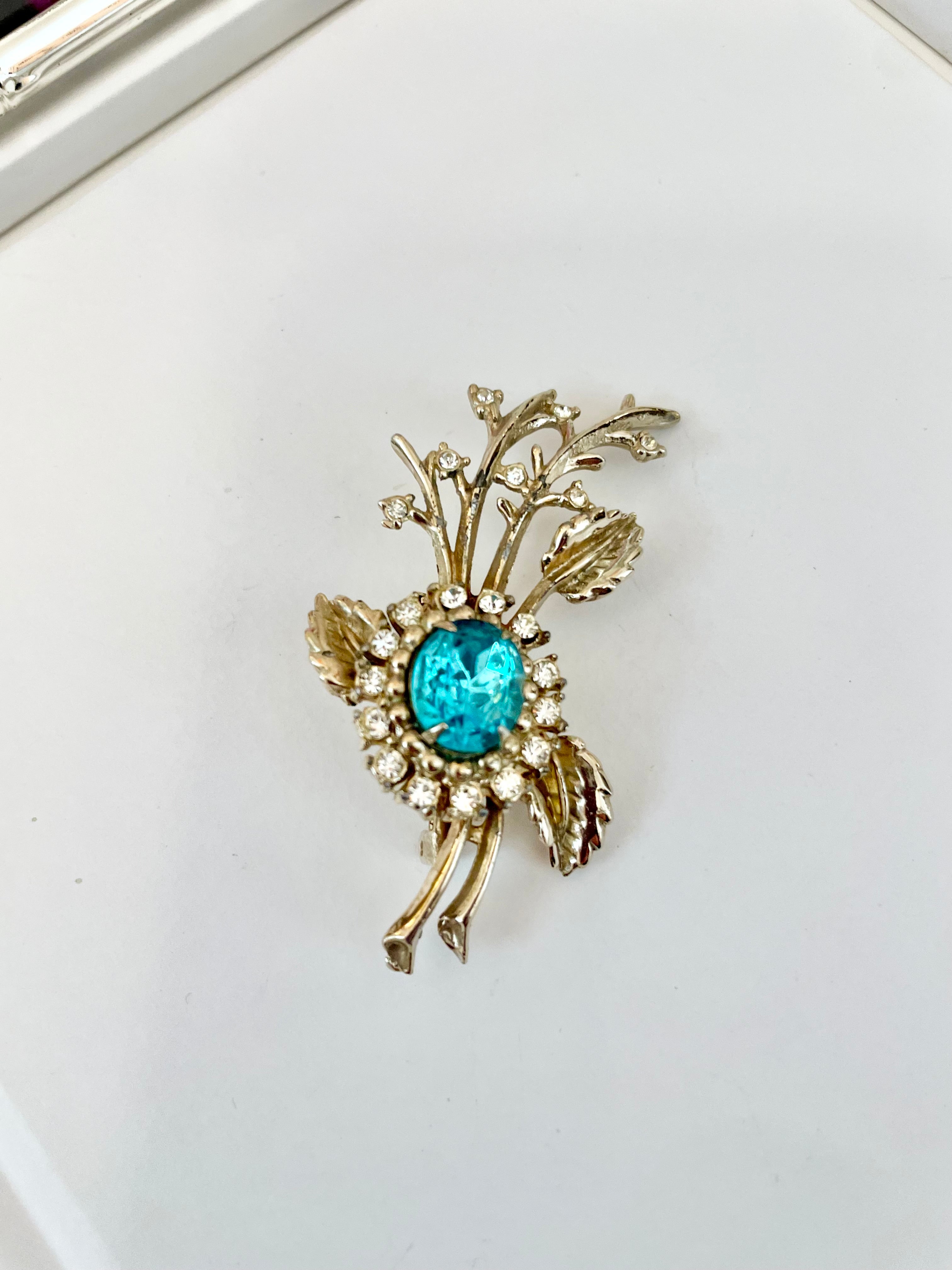 The happy hostess loves a colorful brooch... oh so divine!