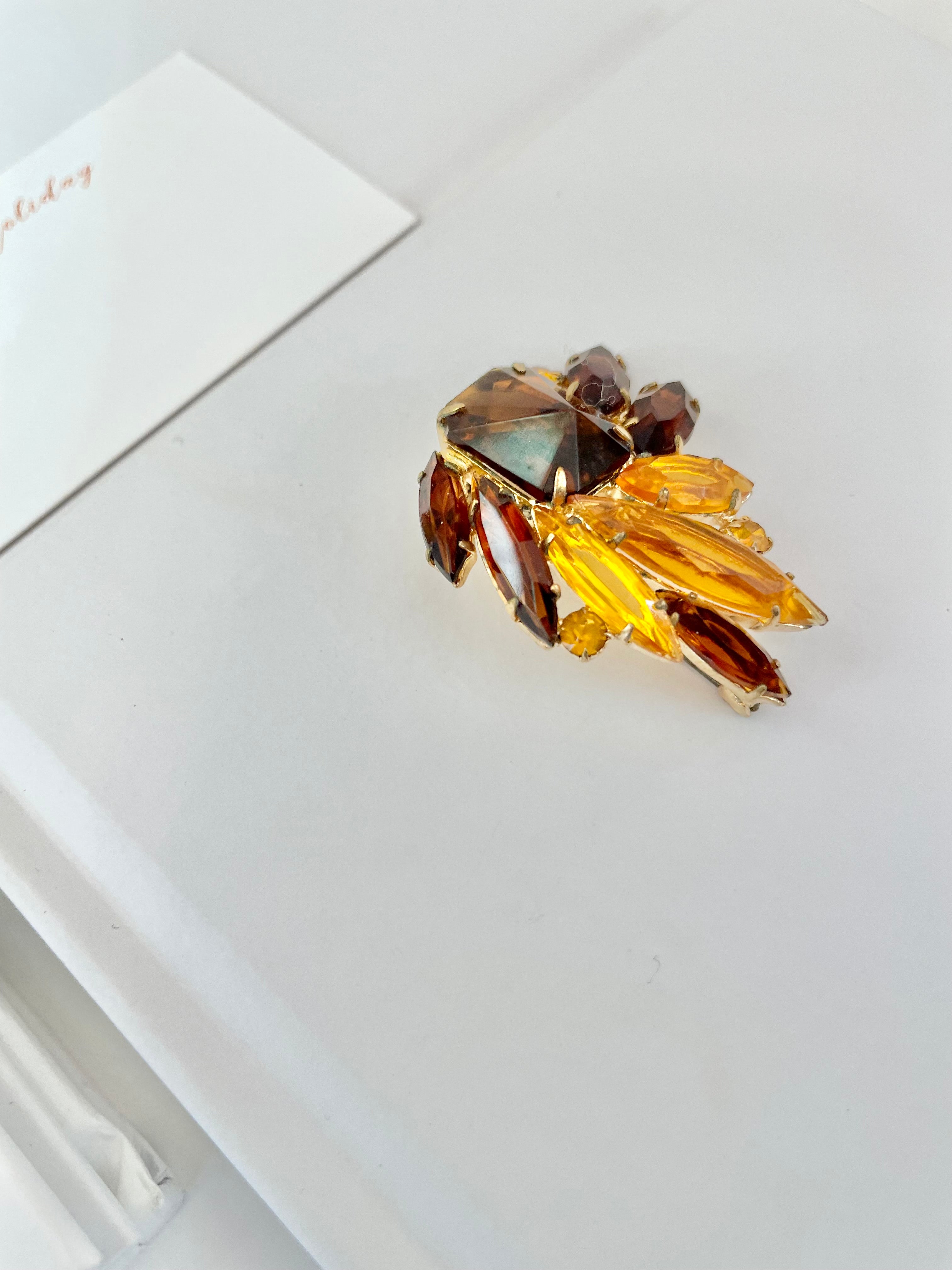 The Socialite and her love of the classic brooch. This 1960's faux glass smoky topaz brooch is truly divine!