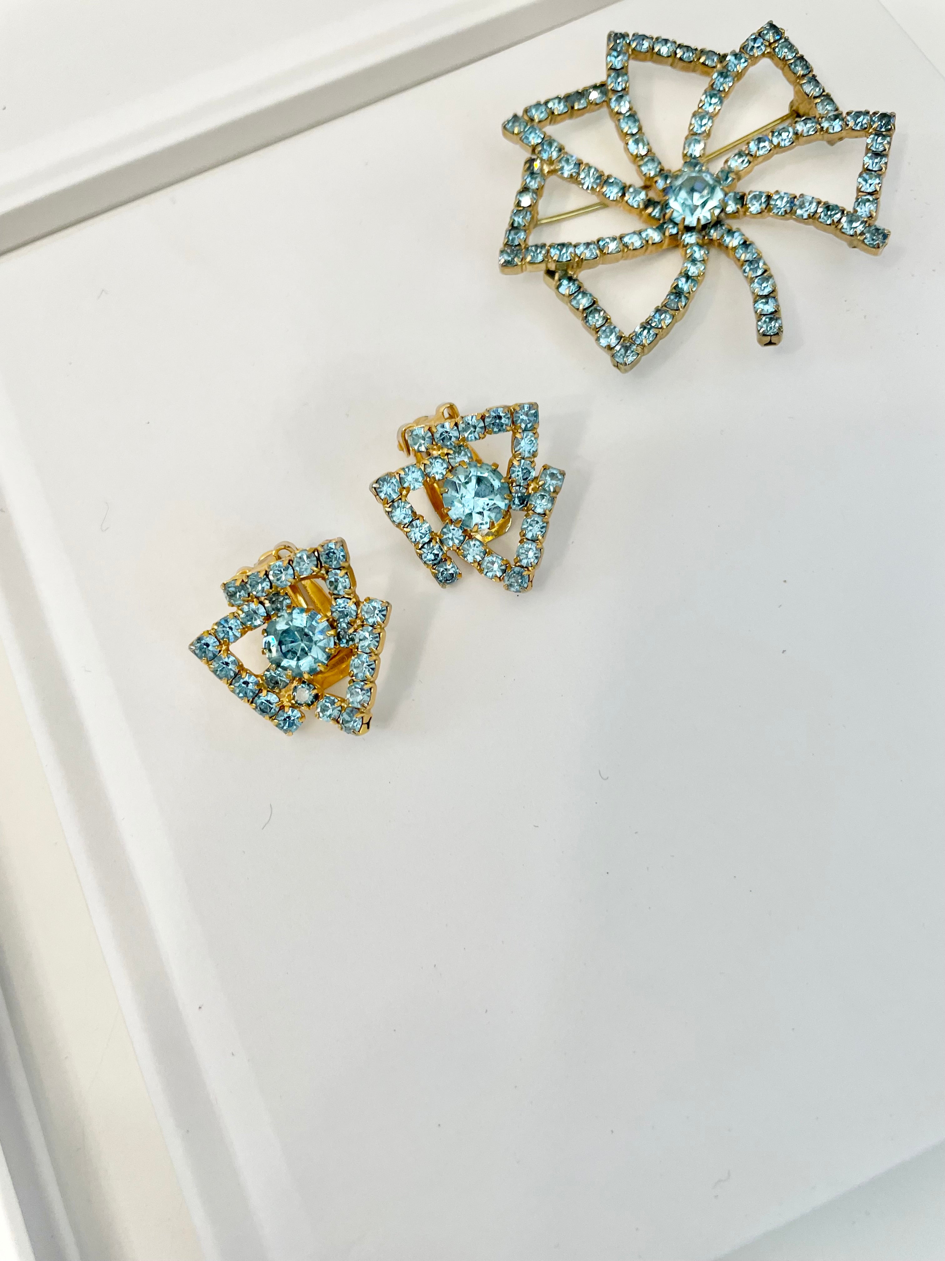 1960's Heiress and her love of a classy brooch set. This aqua glass brooch and earrings are truly divine.