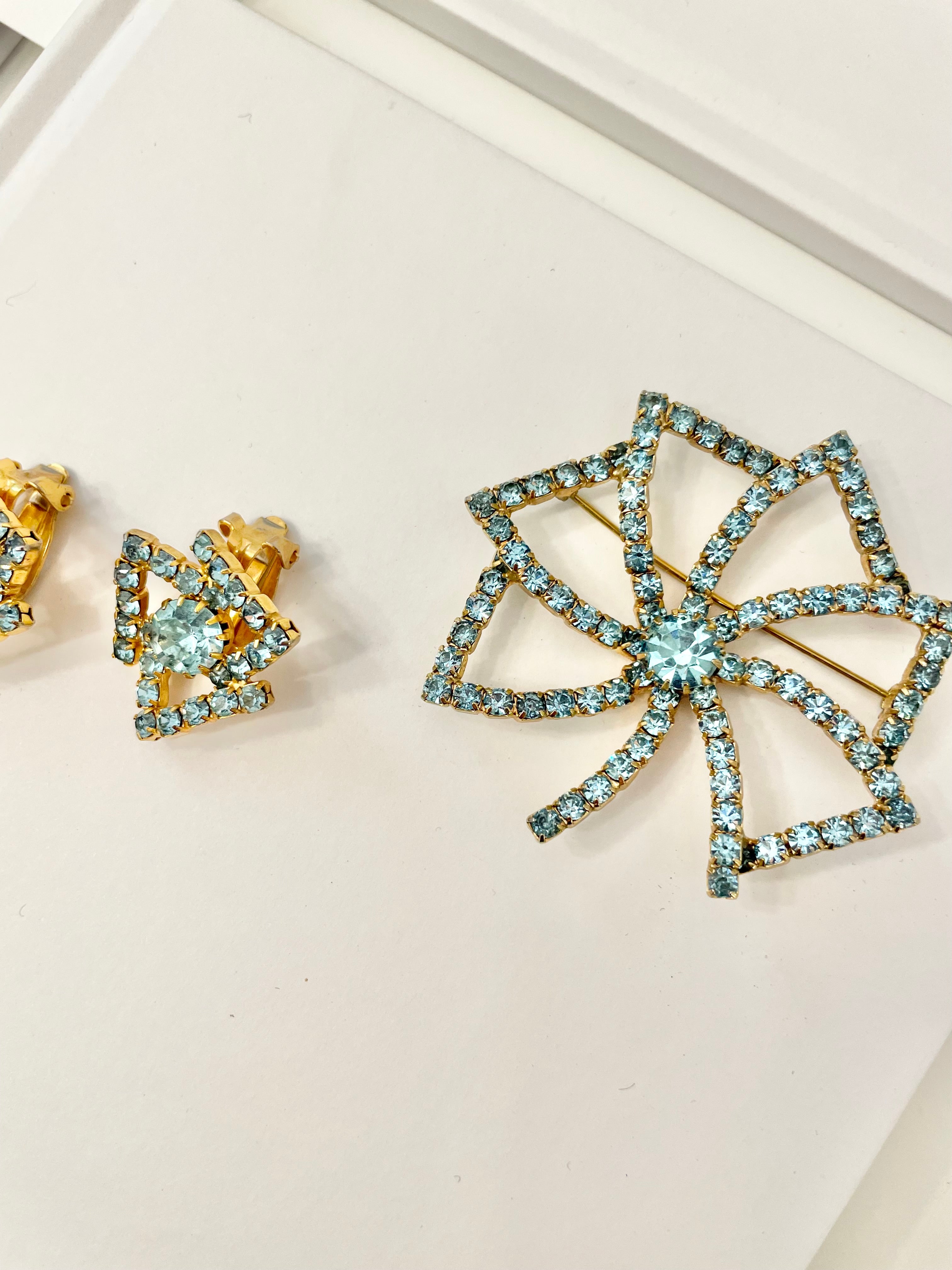 1960's Heiress and her love of a classy brooch set. This aqua glass brooch and earrings are truly divine.