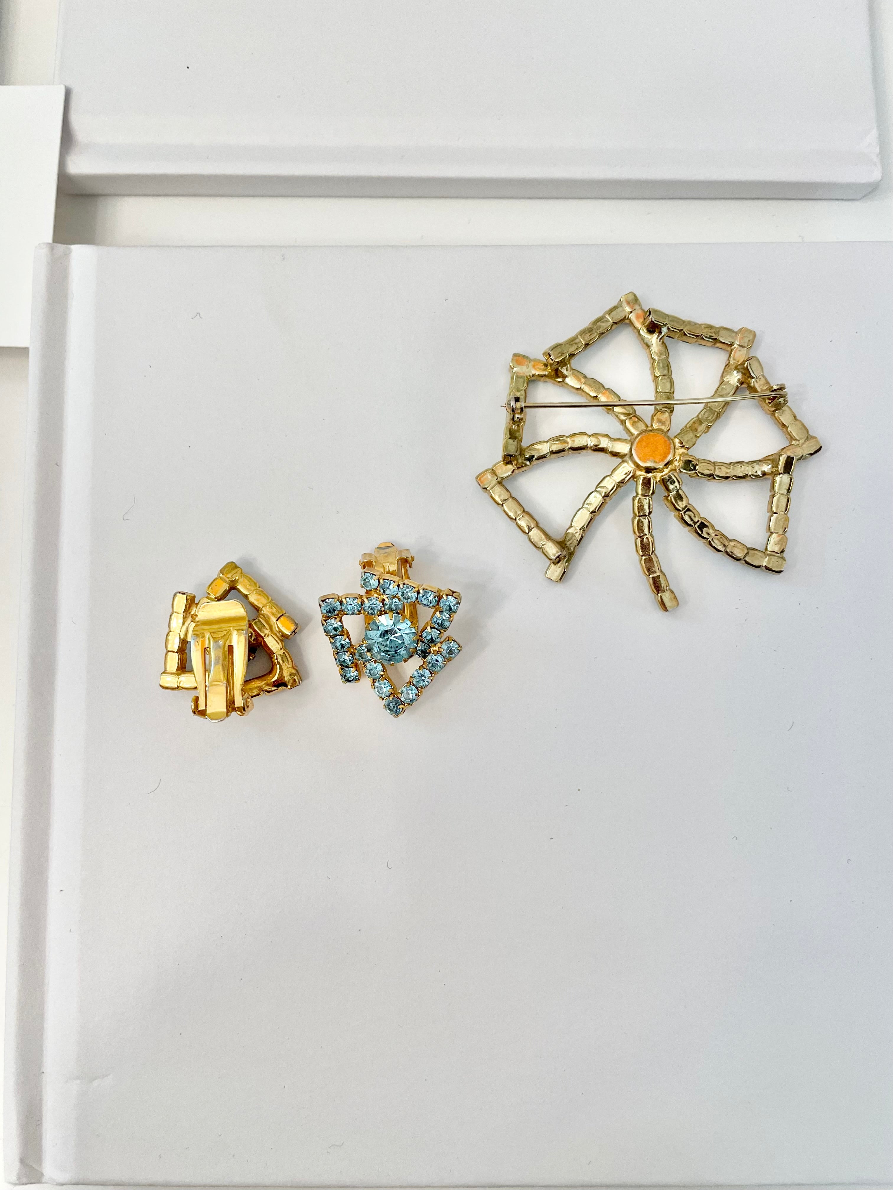 1960's Heiress and her love of a classy brooch set. This aqua glass brooch and earrings are truly divine.