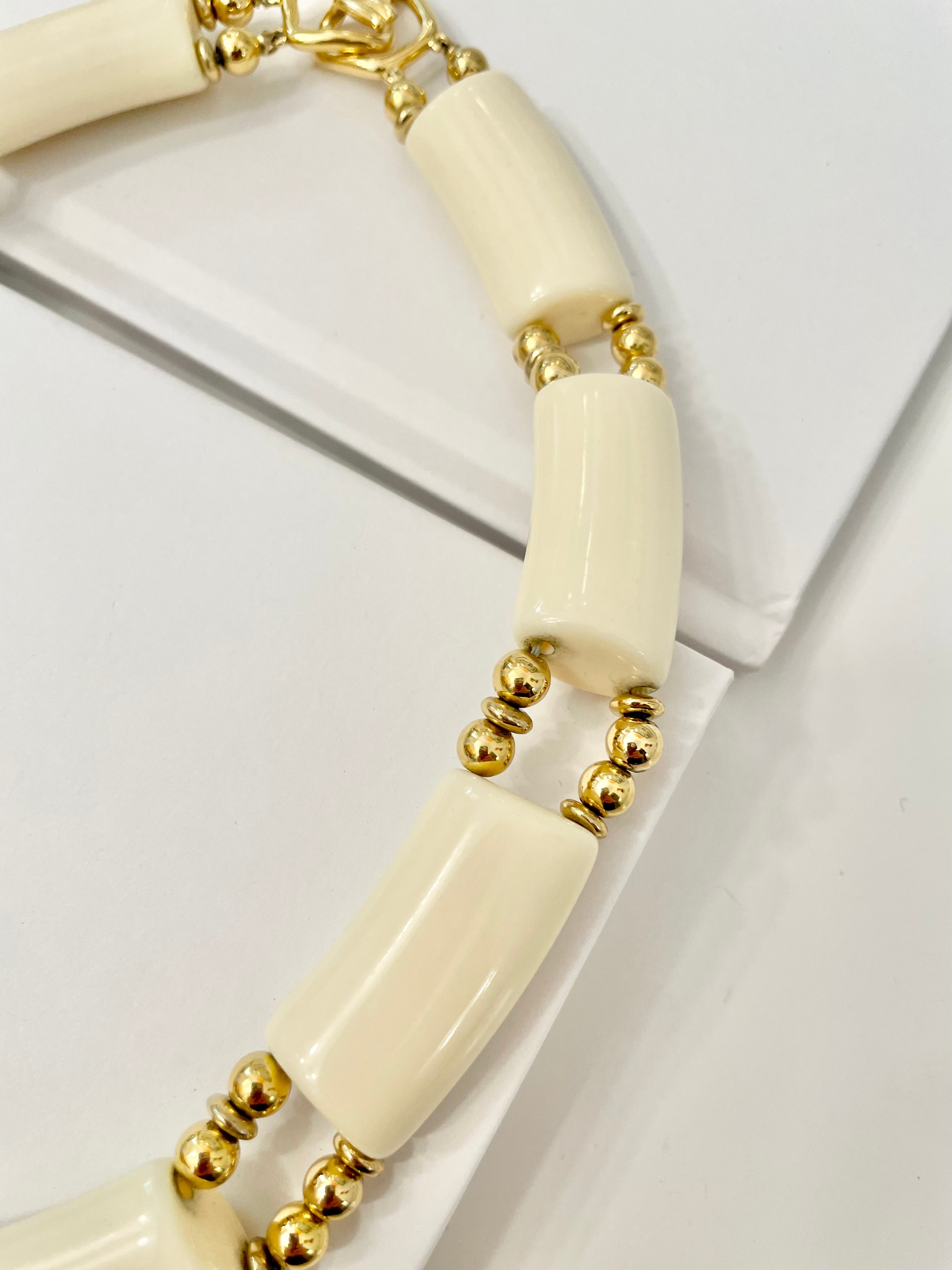 The Socialite loves a classic necklace... this ivory resin, and gold bead collar necklace is truly classy, and chic