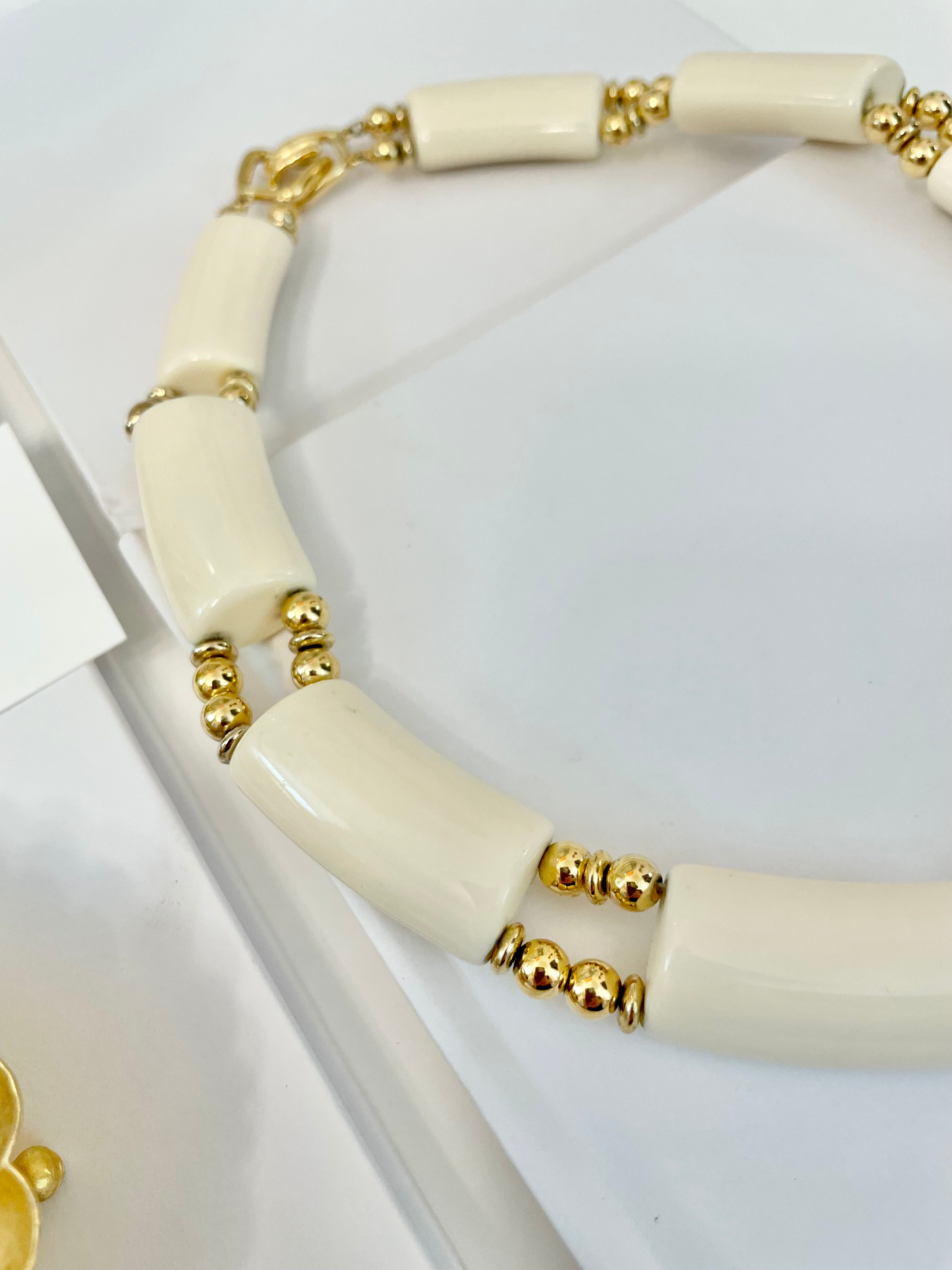 The Socialite loves a classic necklace... this ivory resin, and gold bead collar necklace is truly classy, and chic