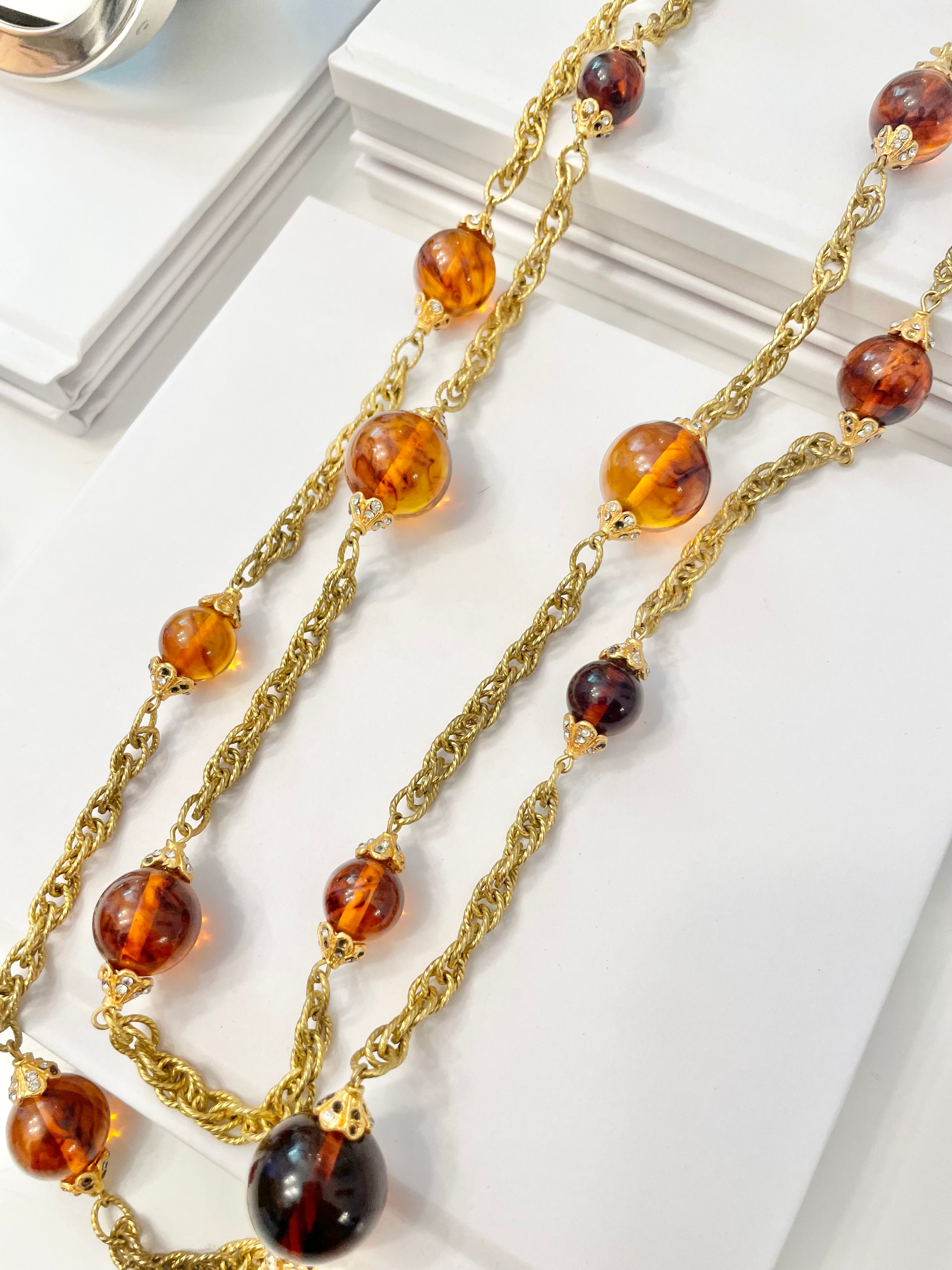 This lovely long, gold and tortoise glass beaded necklace is a truly classy piece. So lovely