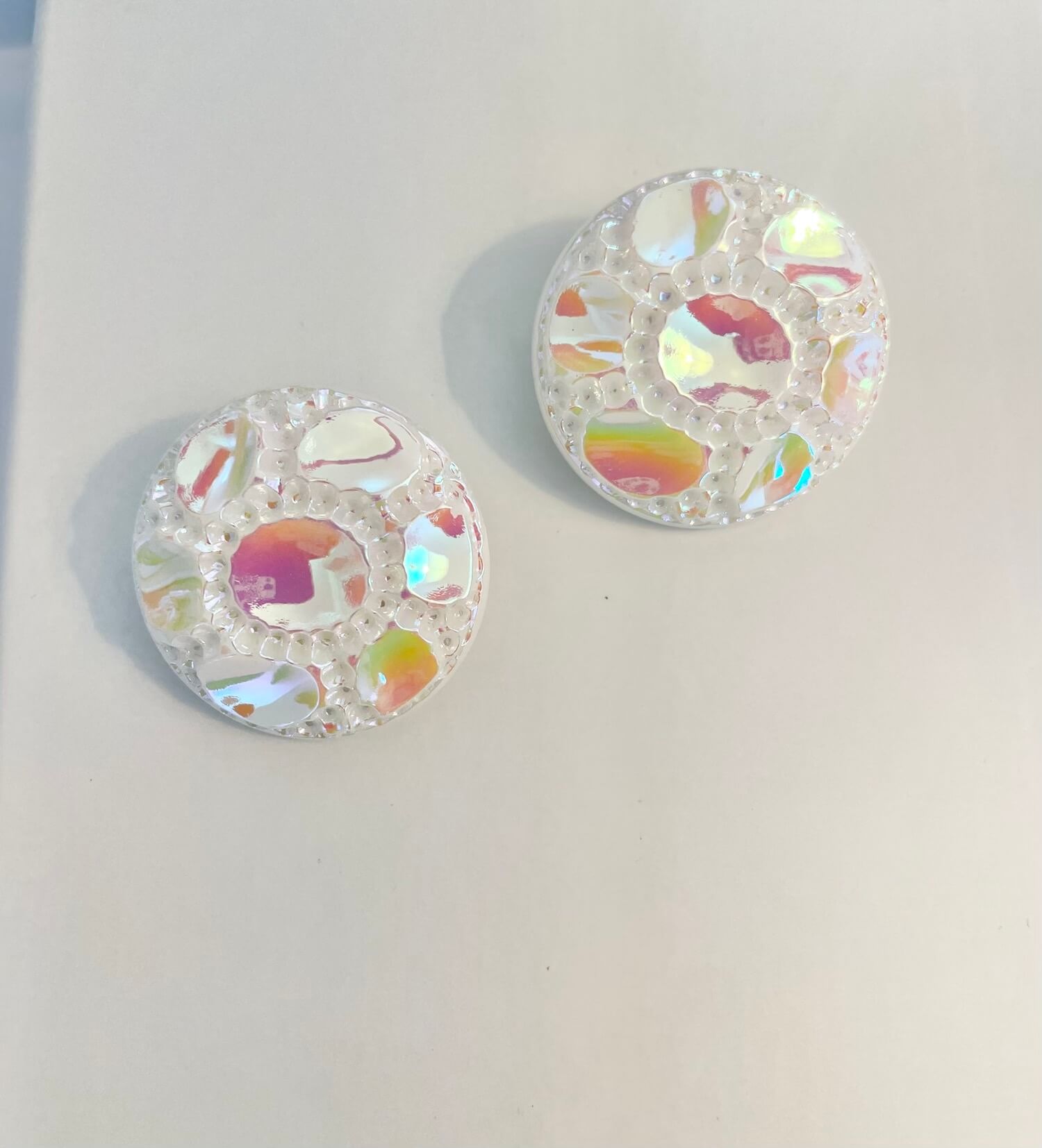 Vintage 1970's shimmery white button clip earrings.