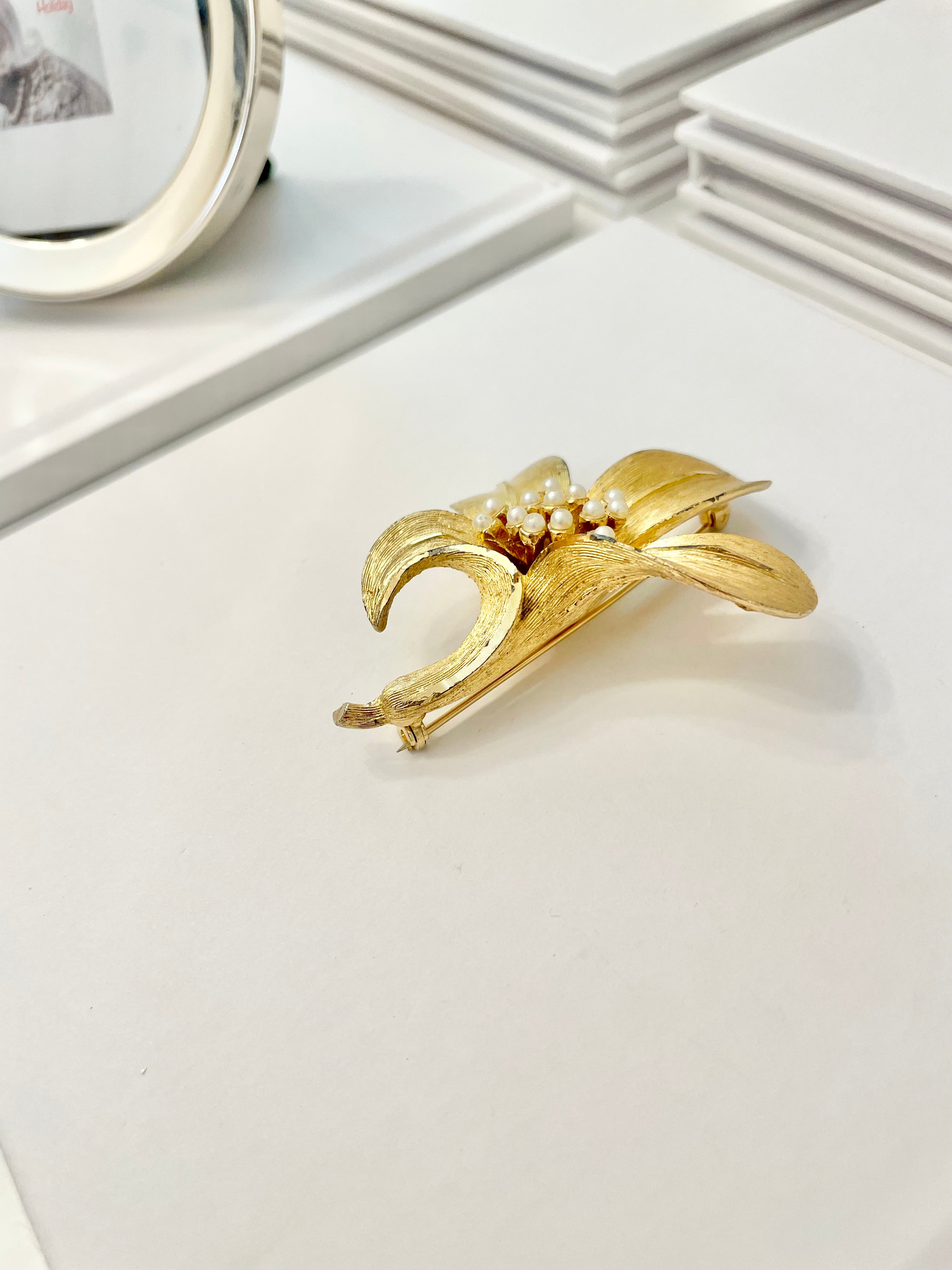 Isn't she charming... adores anything with pearls! This divine gold sculpted lily brooch is outstanding.