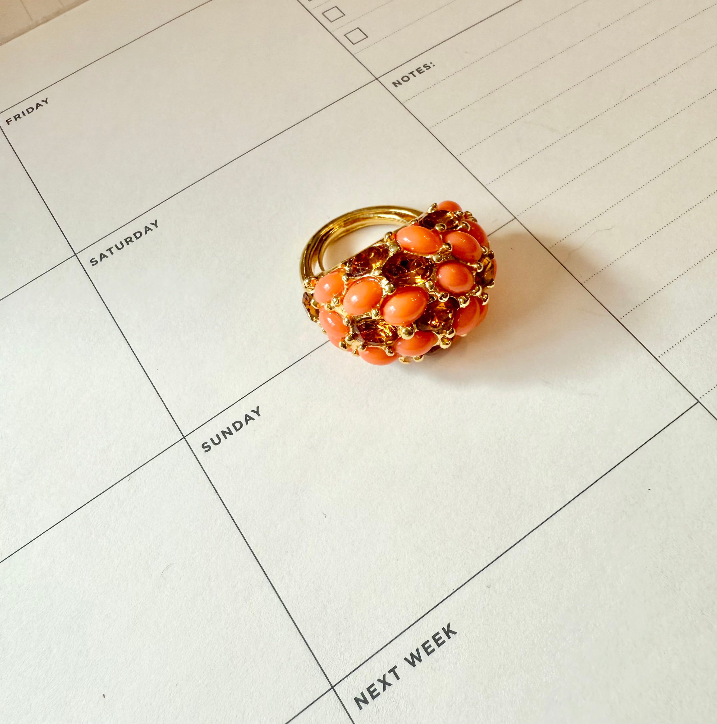 A classy Kenneth Jay Lane faux coral and orange citrine cocktail ring...