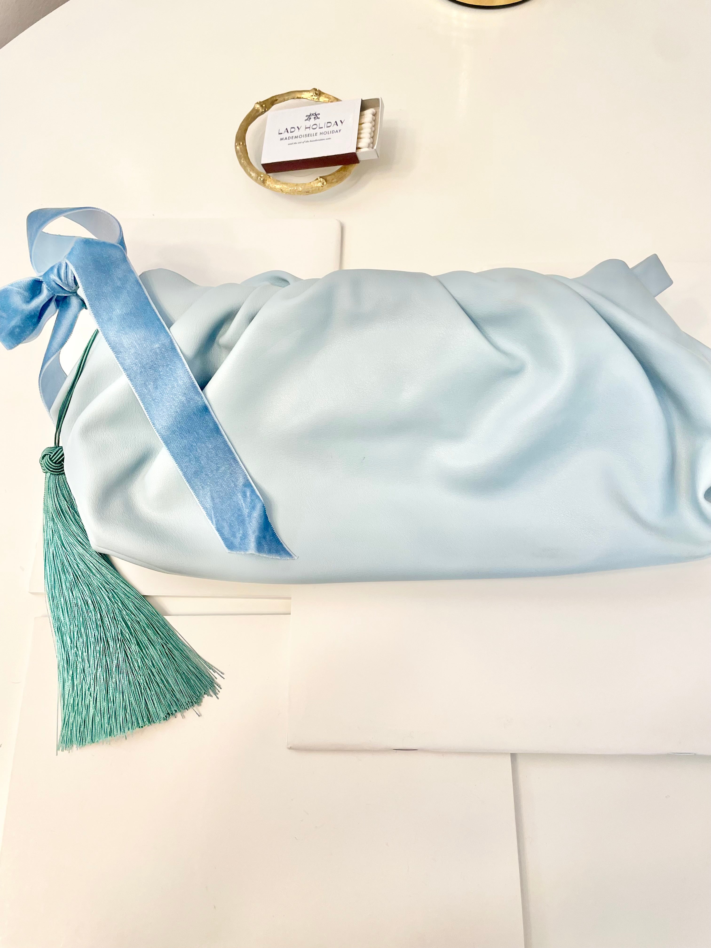 The most feminine soft blue tassel clutch bag... so lovely