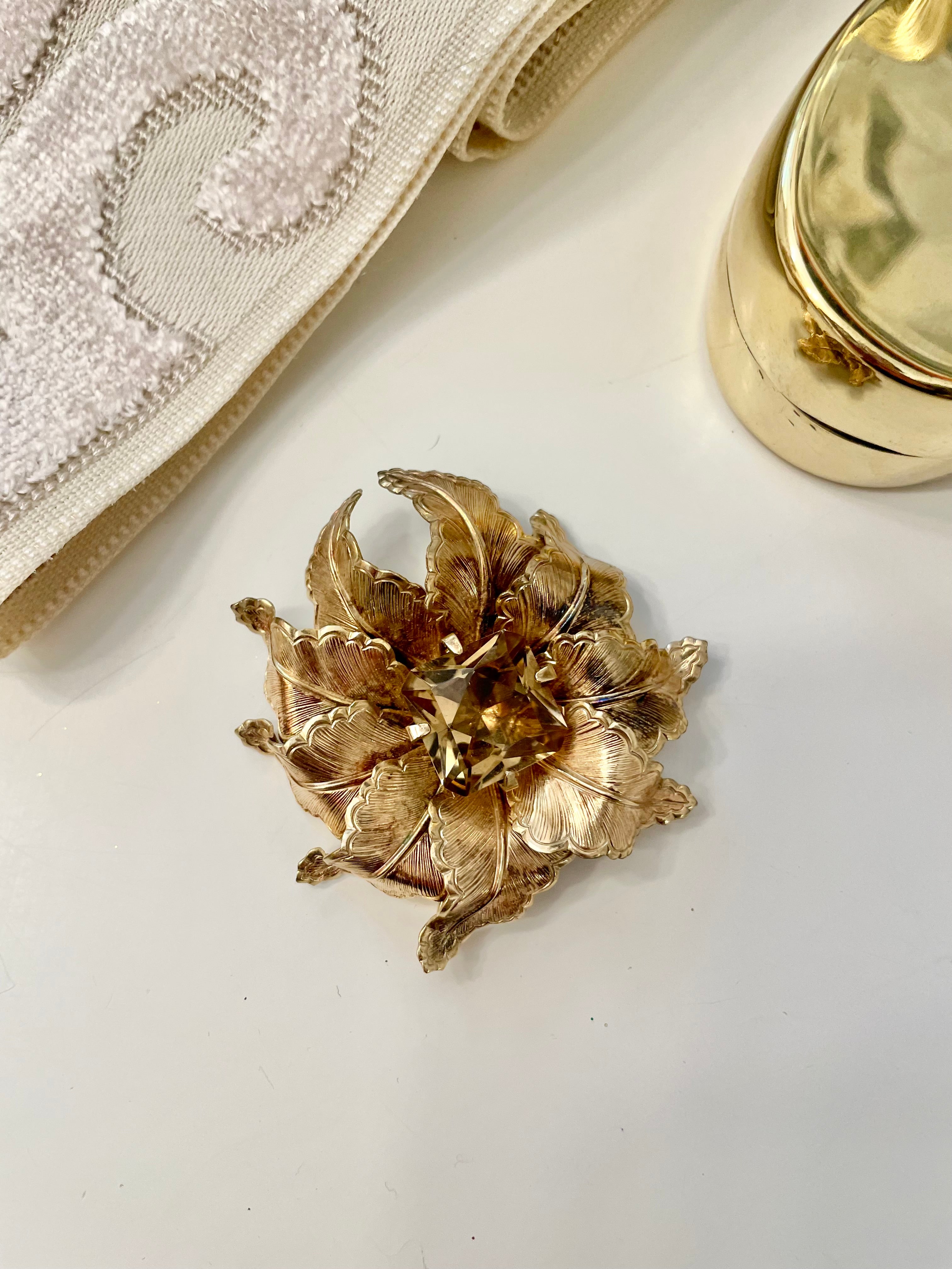 The most lovely estate gold flower brooch with topaz center stone....