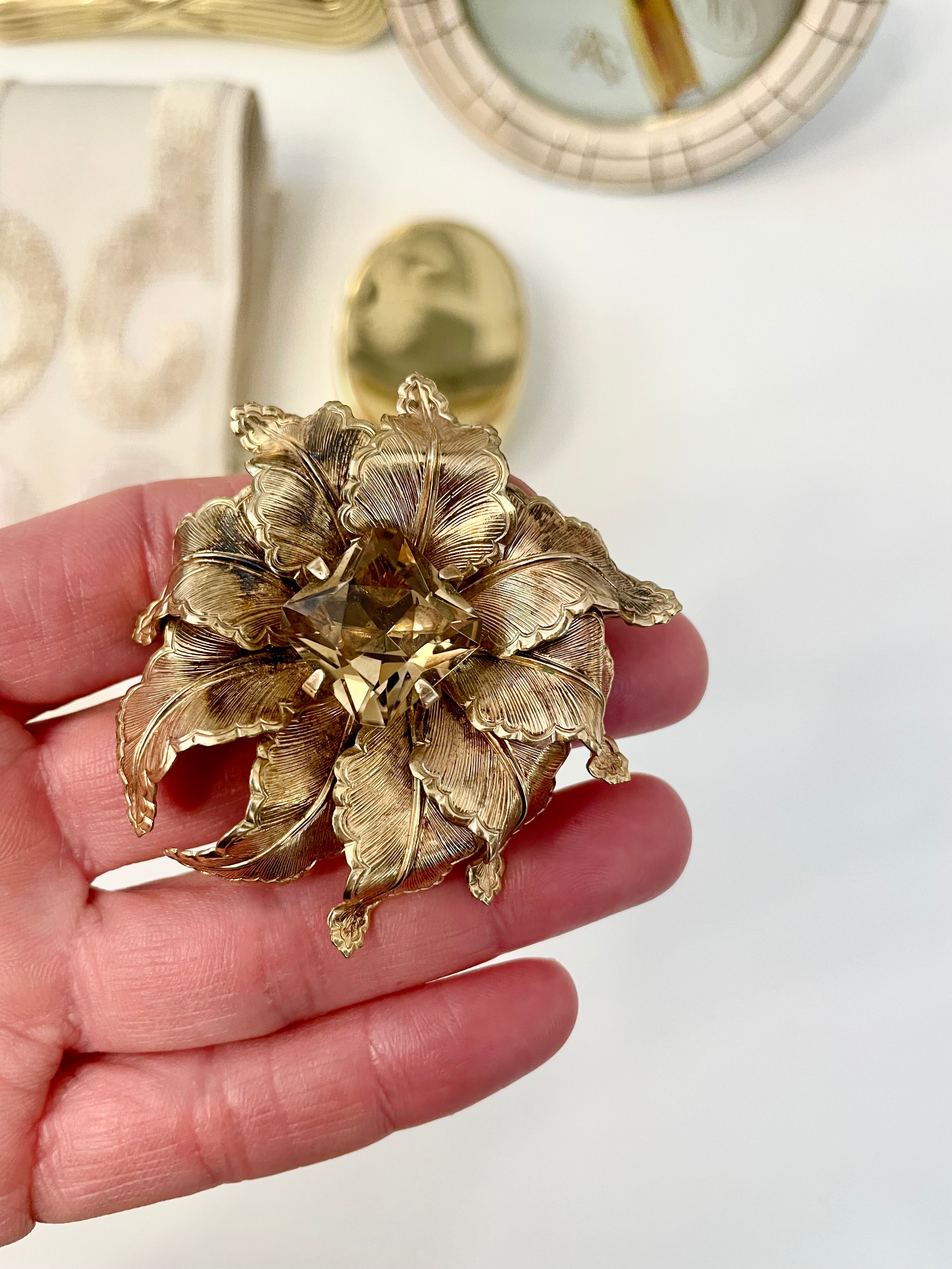 The most lovely estate gold flower brooch with topaz center stone....