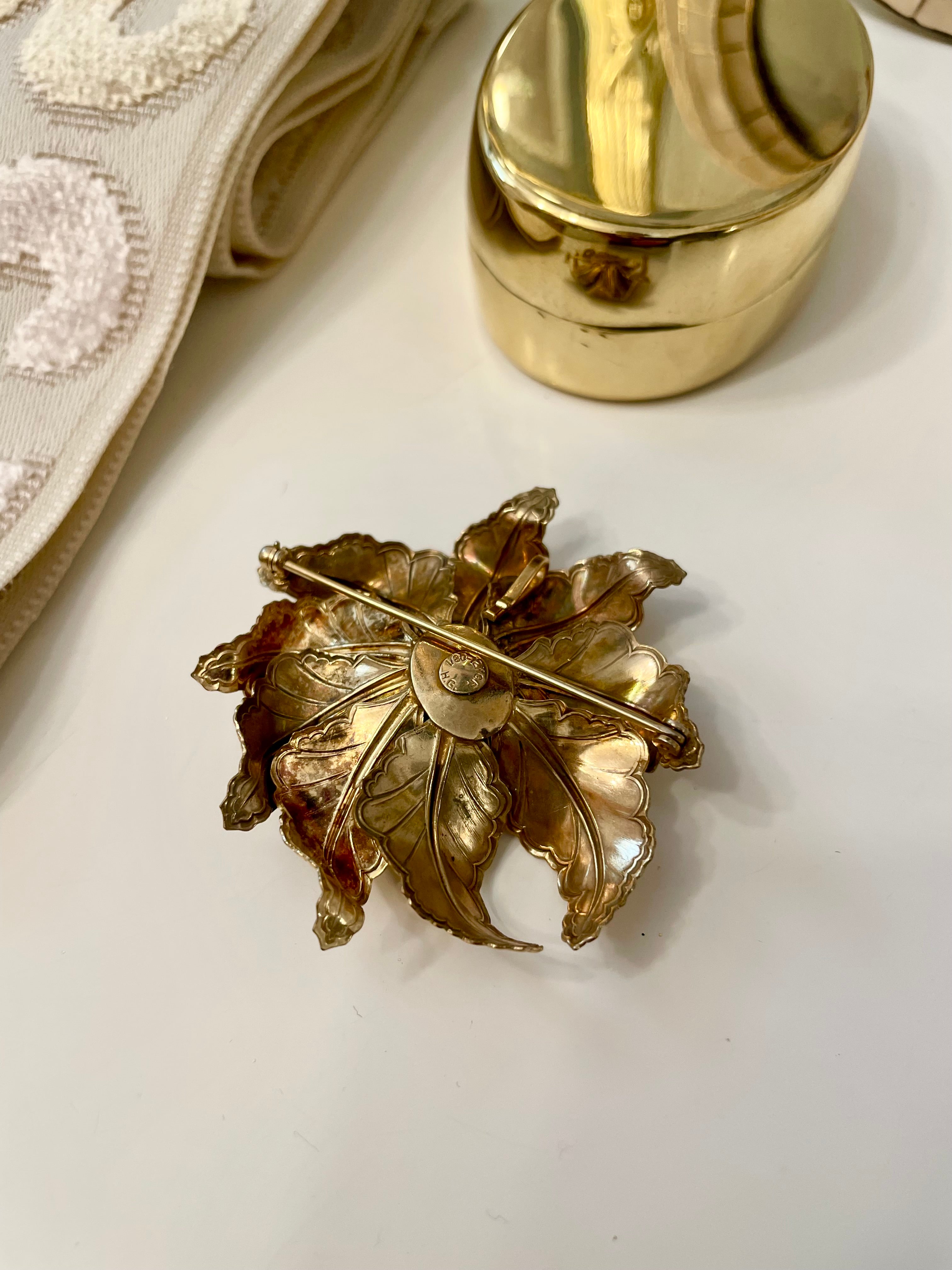 The most lovely estate gold flower brooch with topaz center stone....