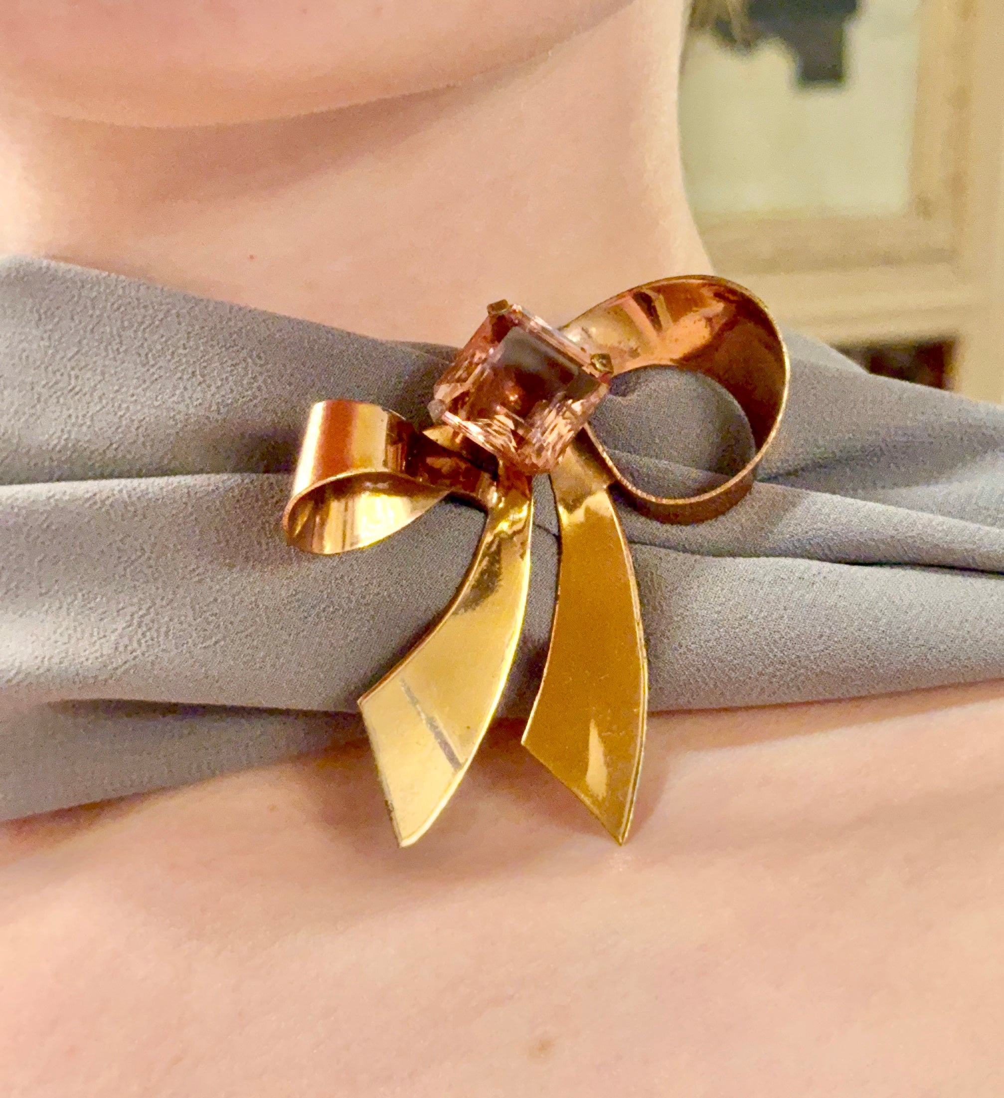 1960's most feminine brass bow with purple glass stone....