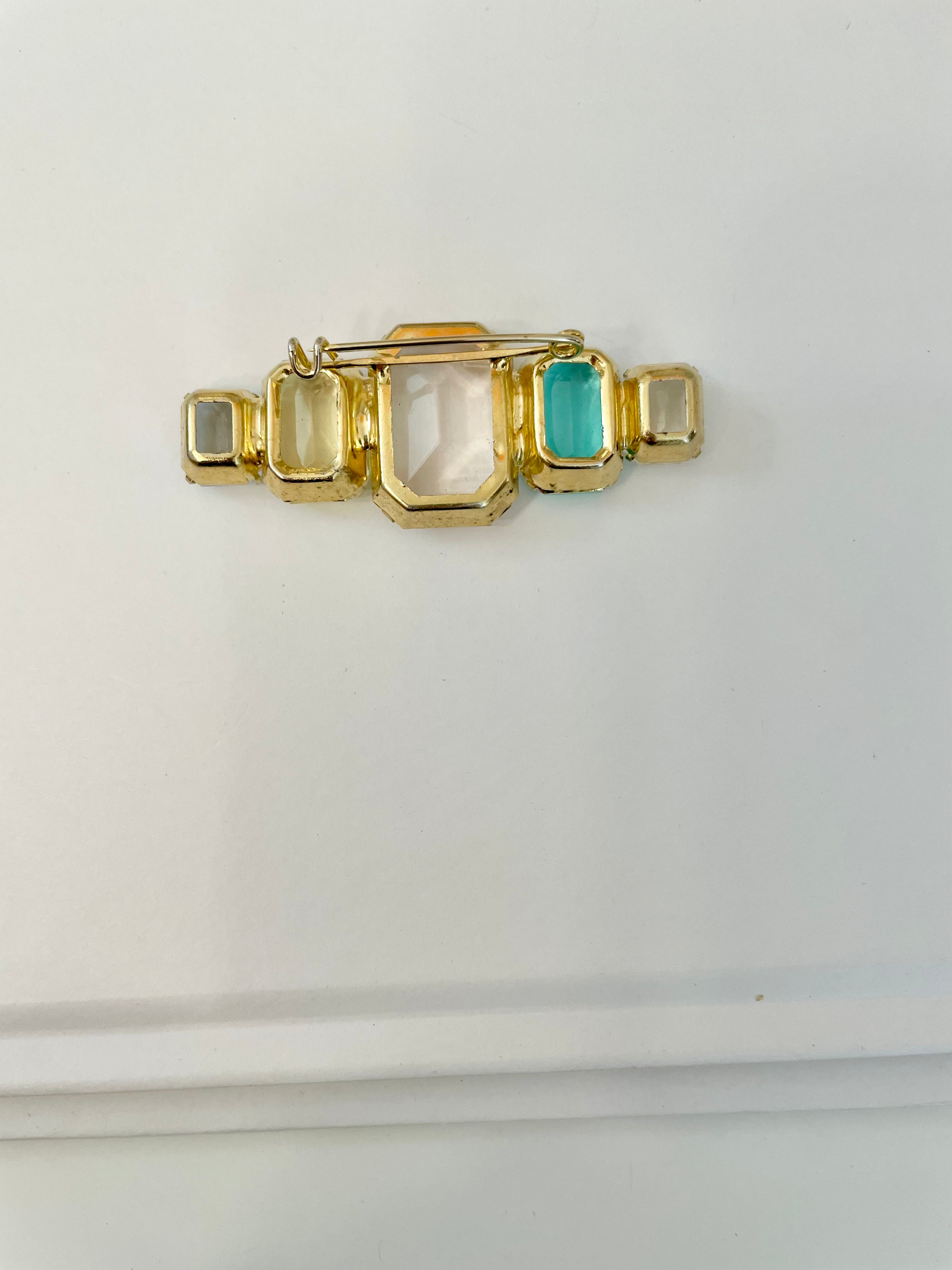 Truly stunning emerald cut stone brooch... so feminine!