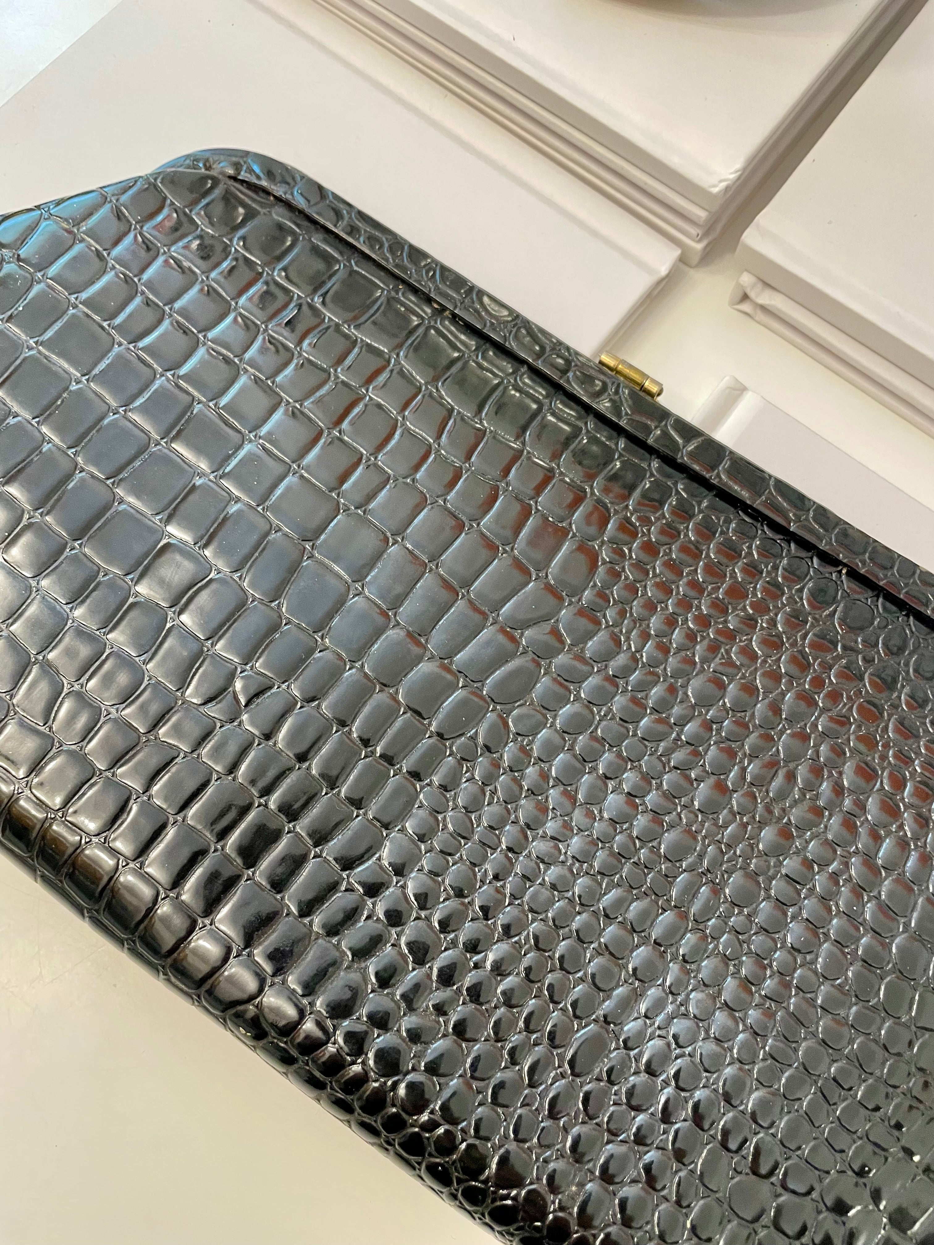 The Socialite and her love of the classy, and the timeless! This faux croco clutch bag is truly divine.